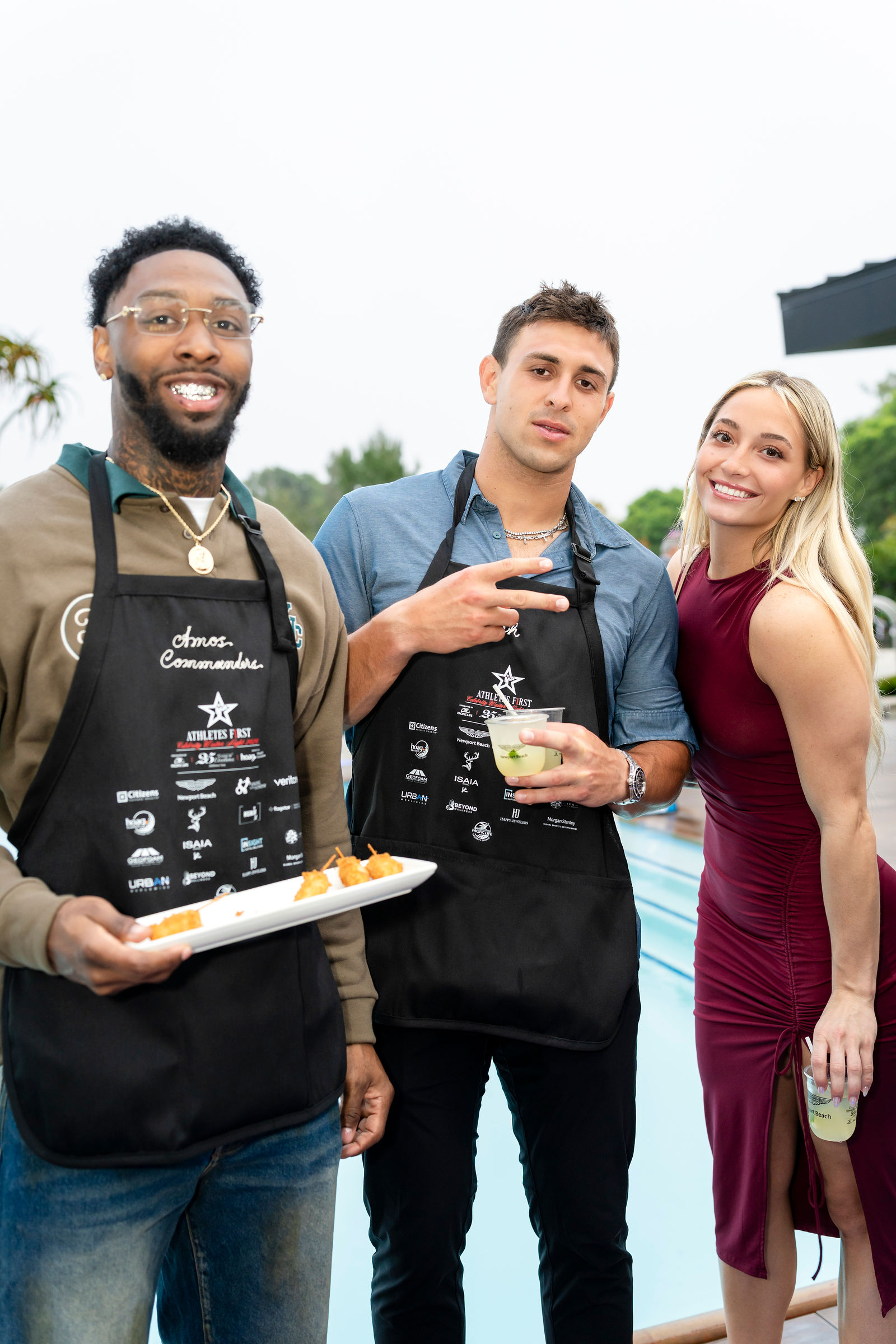 Two athletes and a guest together by the pool