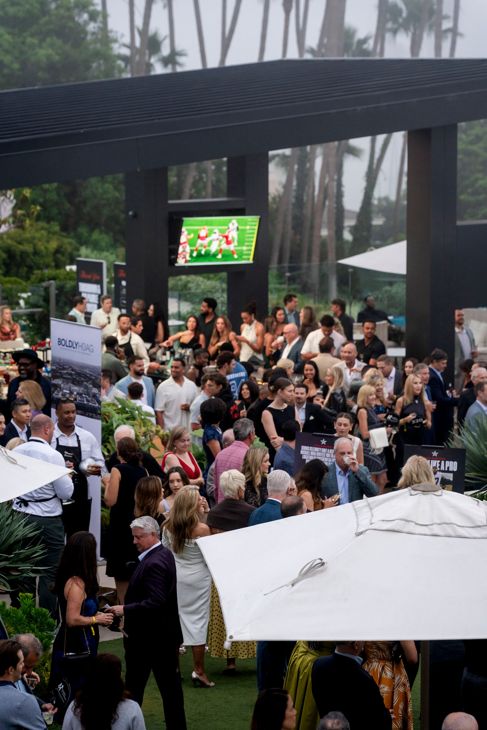Guests filling the venue beneath the pergola, seen from above