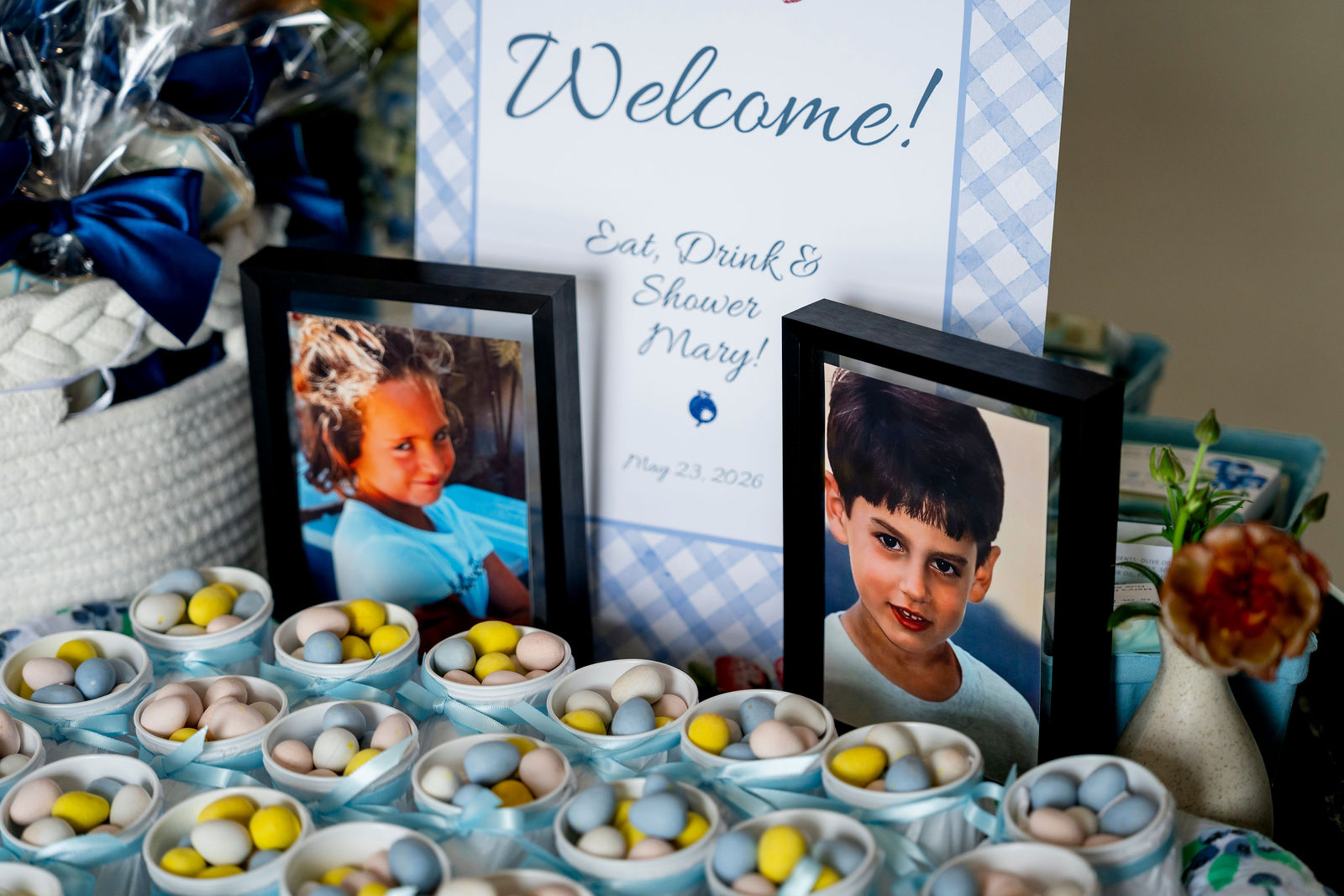 The welcome sign, framed photos and desserts at the baby shower