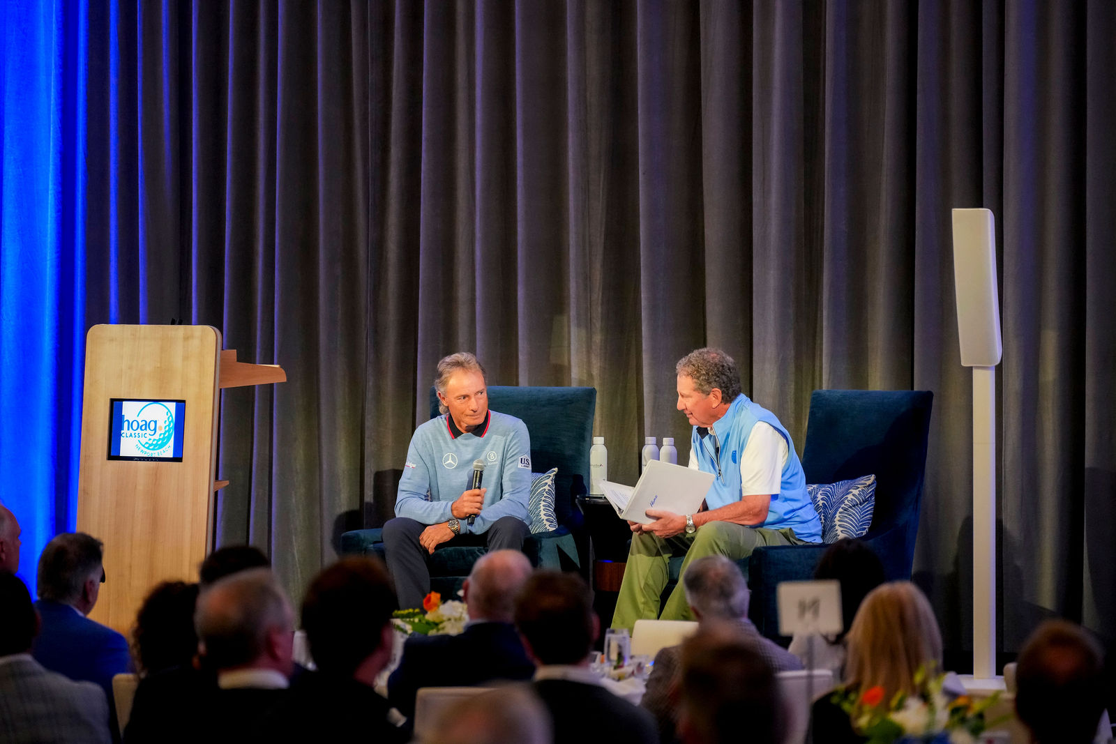 A panel conversation on stage at the community breakfast