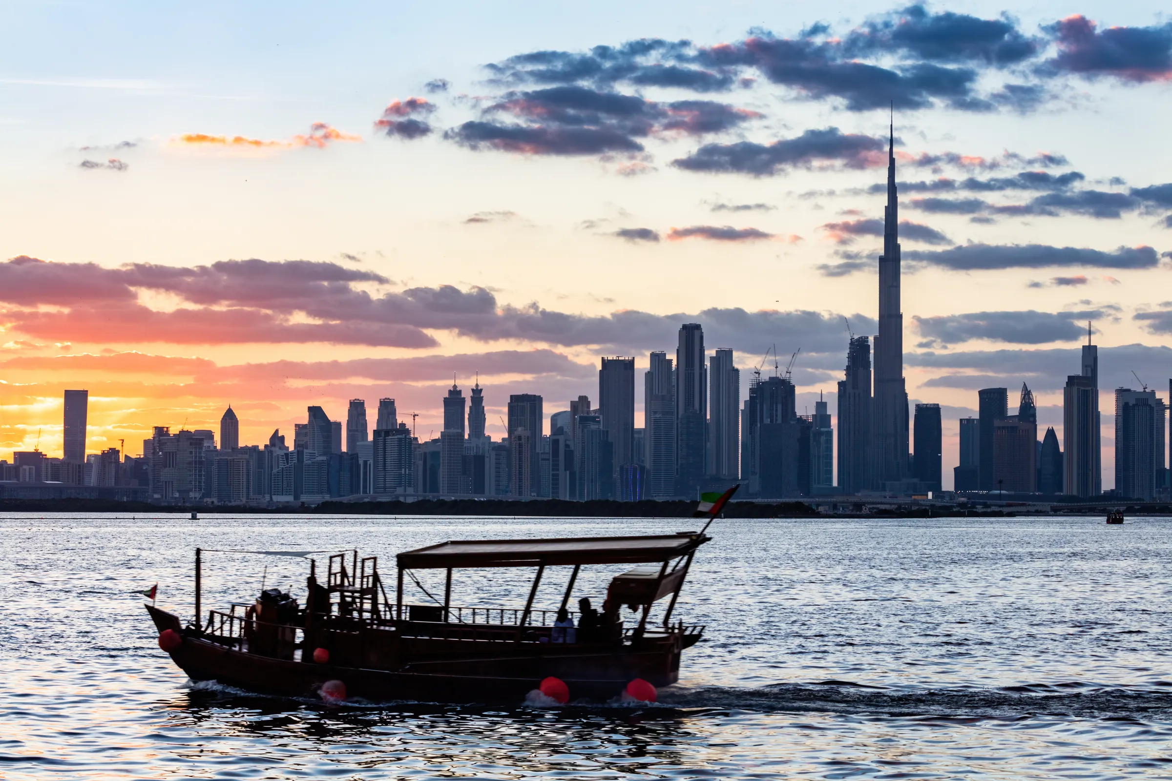 Traditional abra on the water with the Downtown Dubai skyline behind