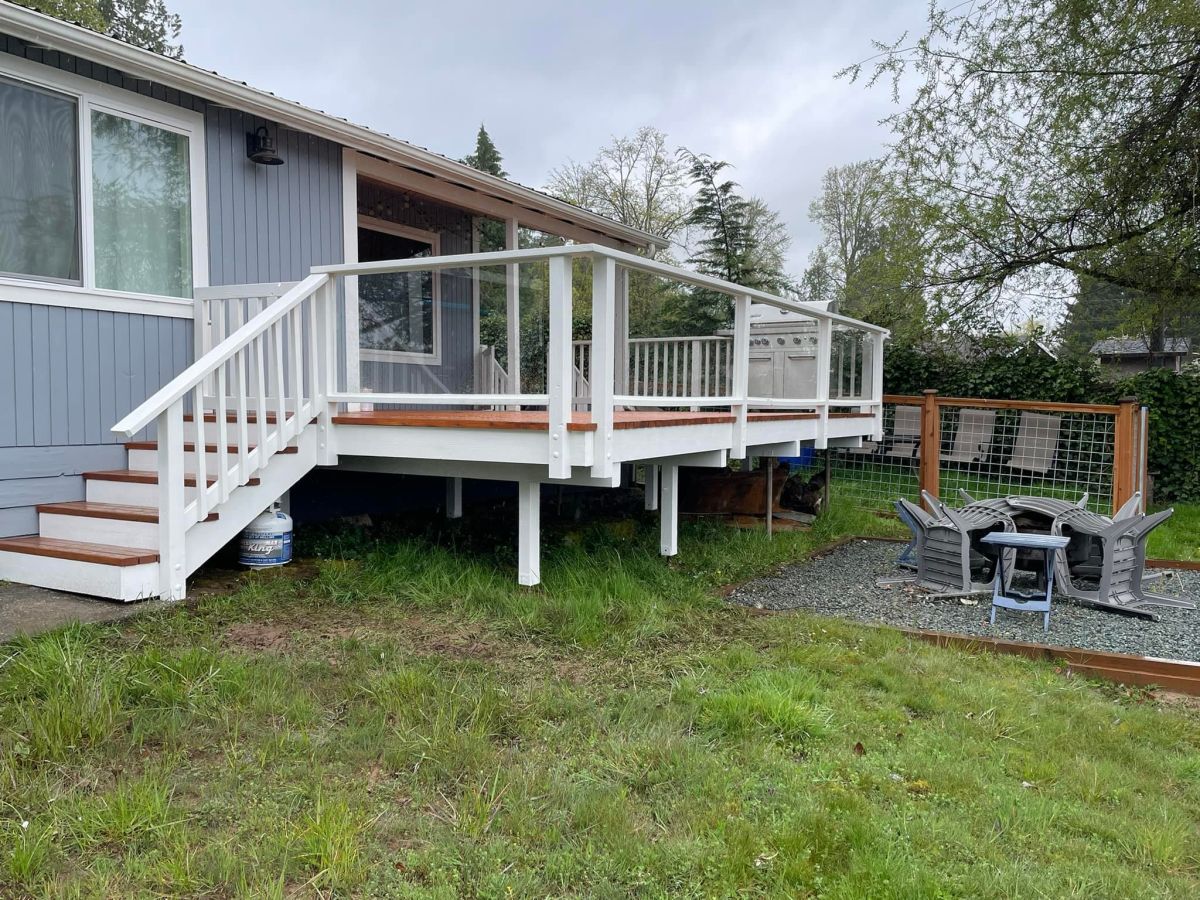Deck with white railings and wood steps