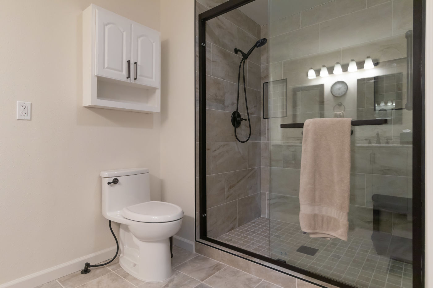 Bathroom remodel by Ultra Renovations with a glass shower enclosure and tiled walls