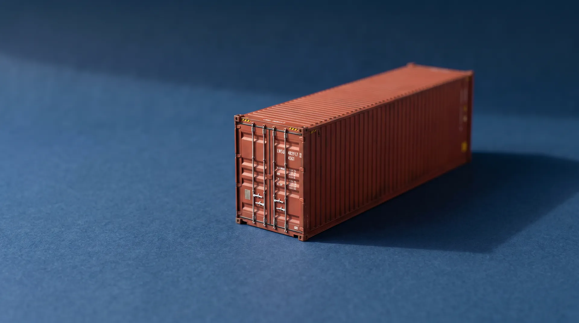 A red shipping container on a deep blue backdrop