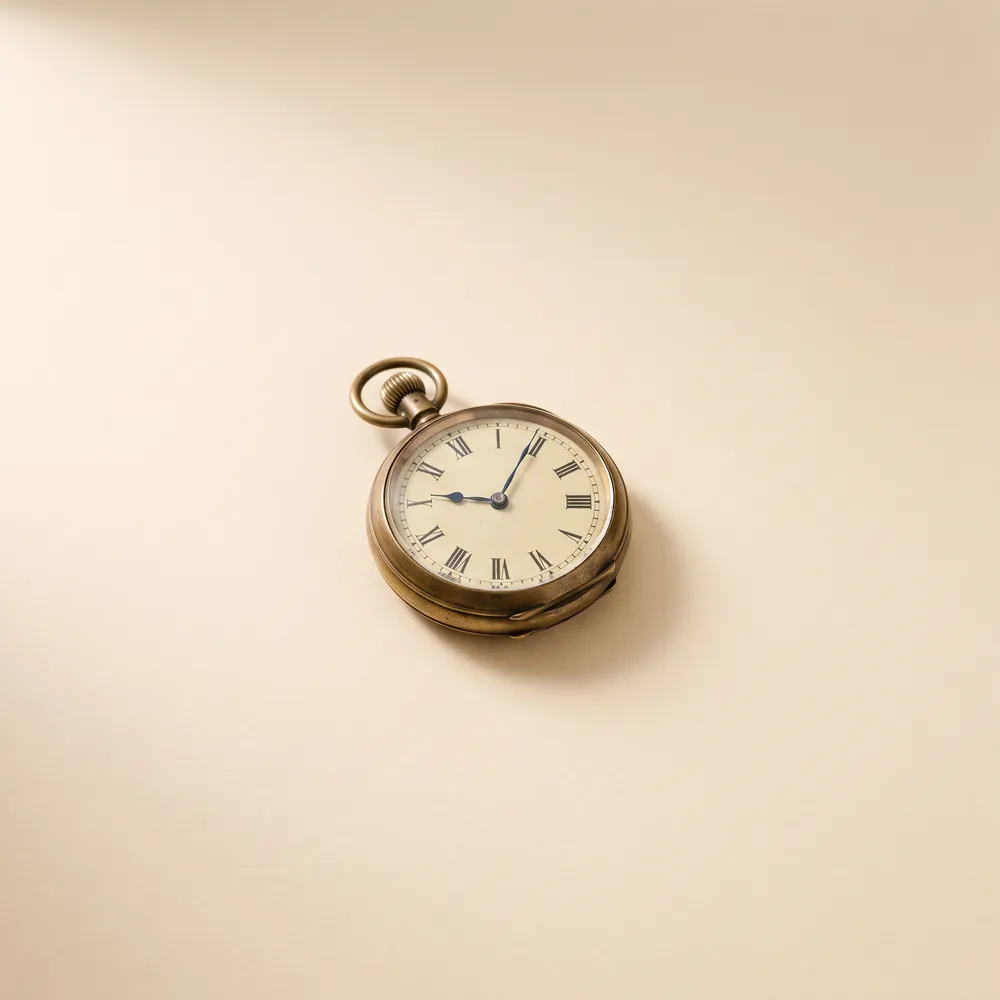 Pocket watch on a white surface