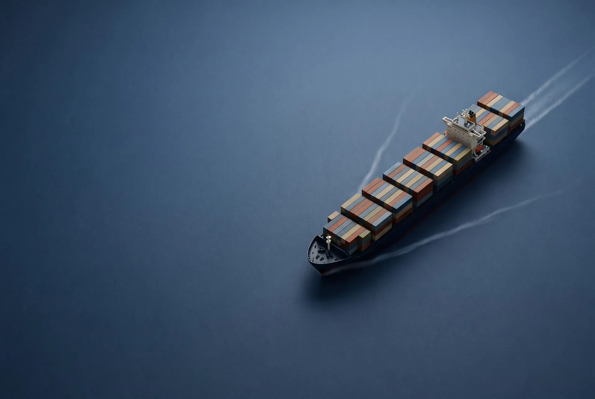 Container ship seen from above on deep blue water