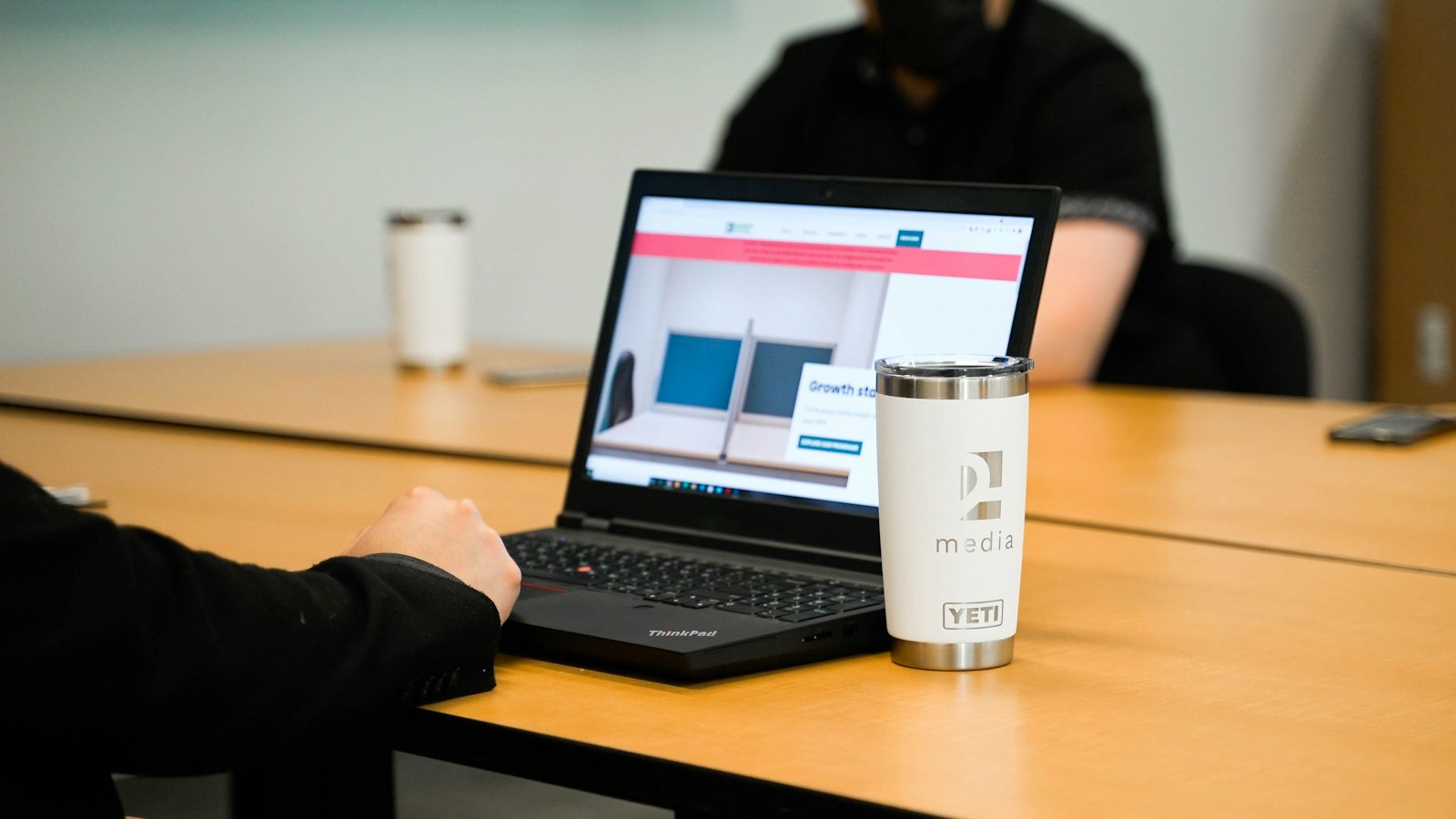 Business laptops in use at an office desk