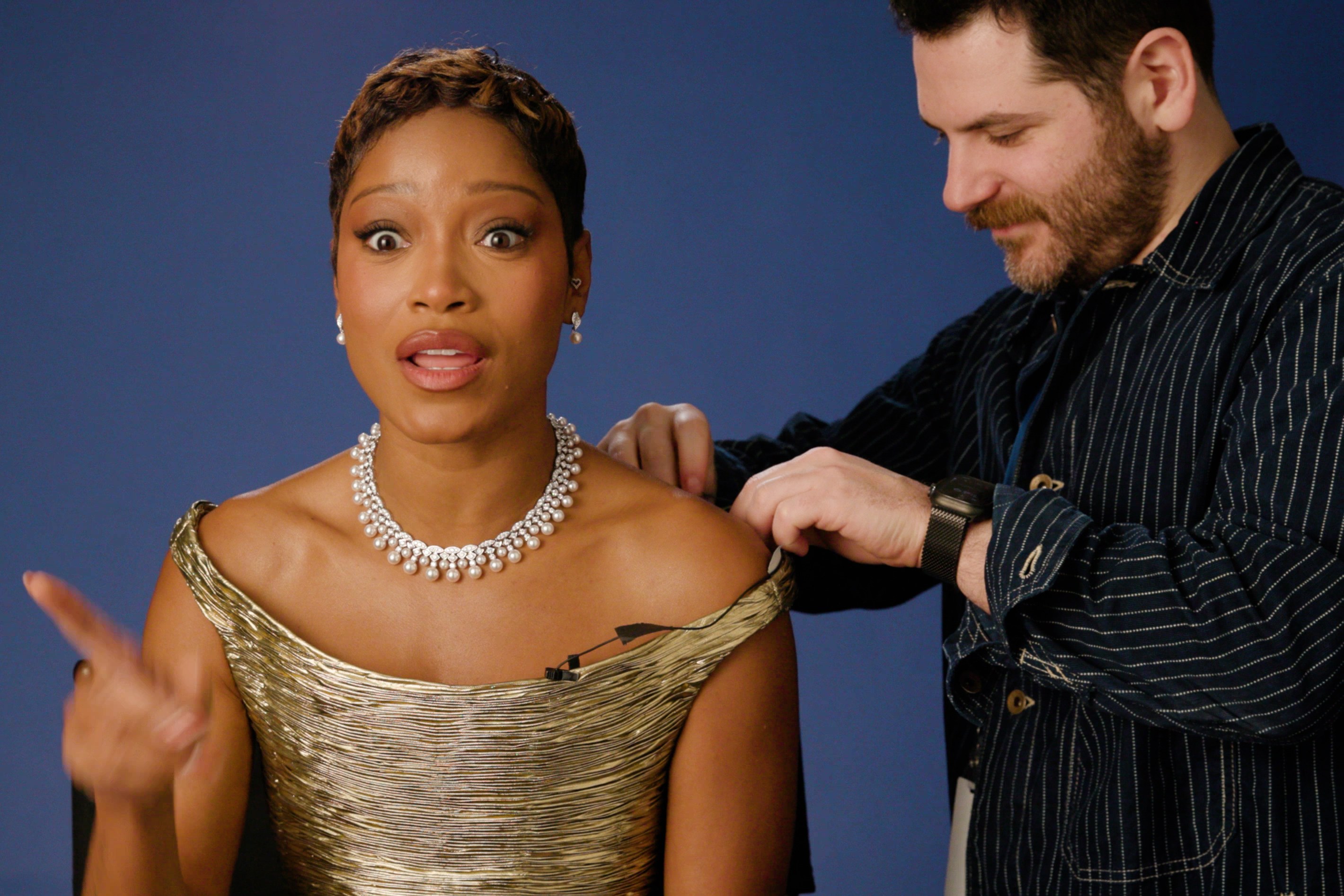 Nick Stango adjusting Keke Palmer's mic on set