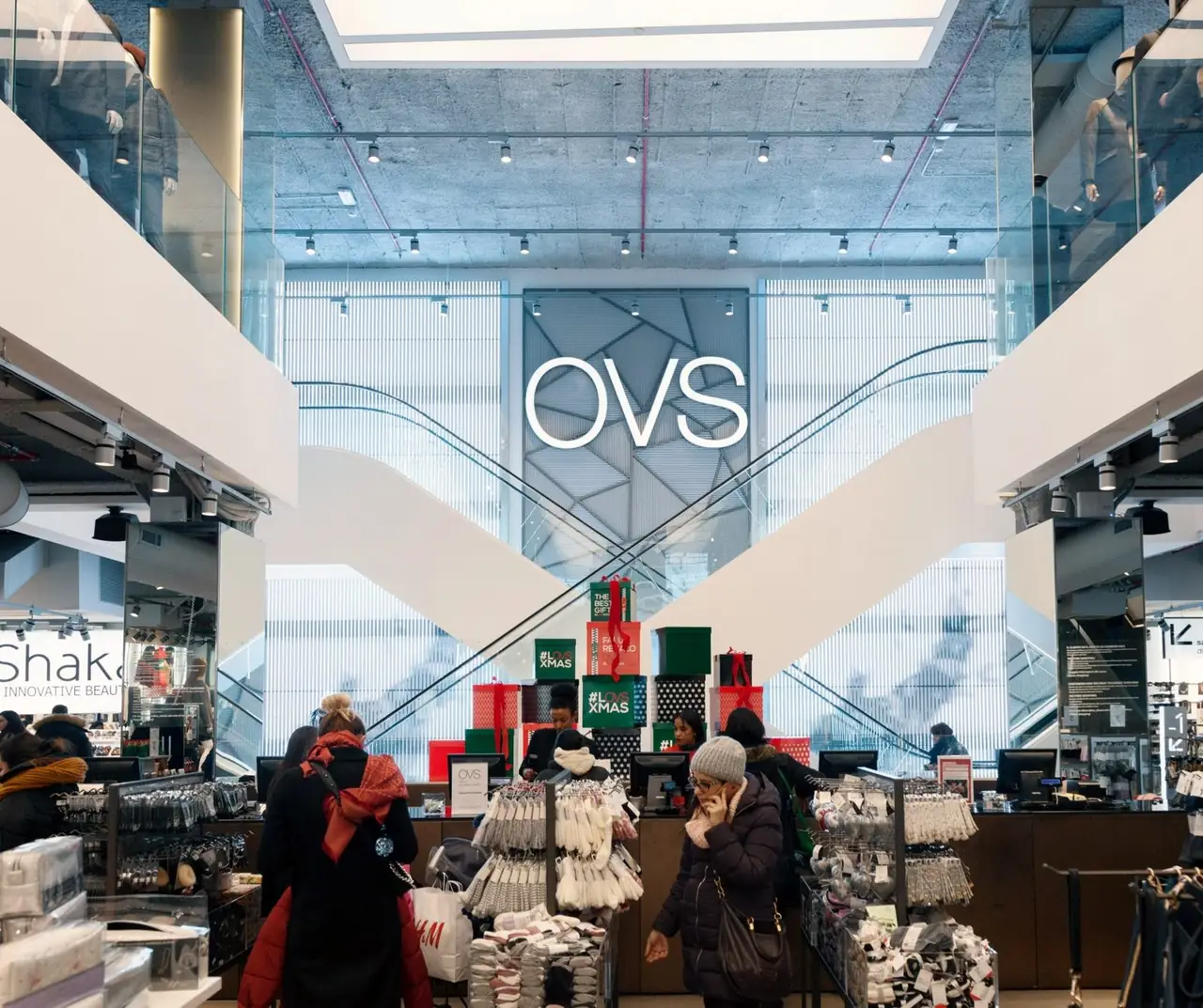Ledwall verticali dietro le scale mobili del flagship store OVS