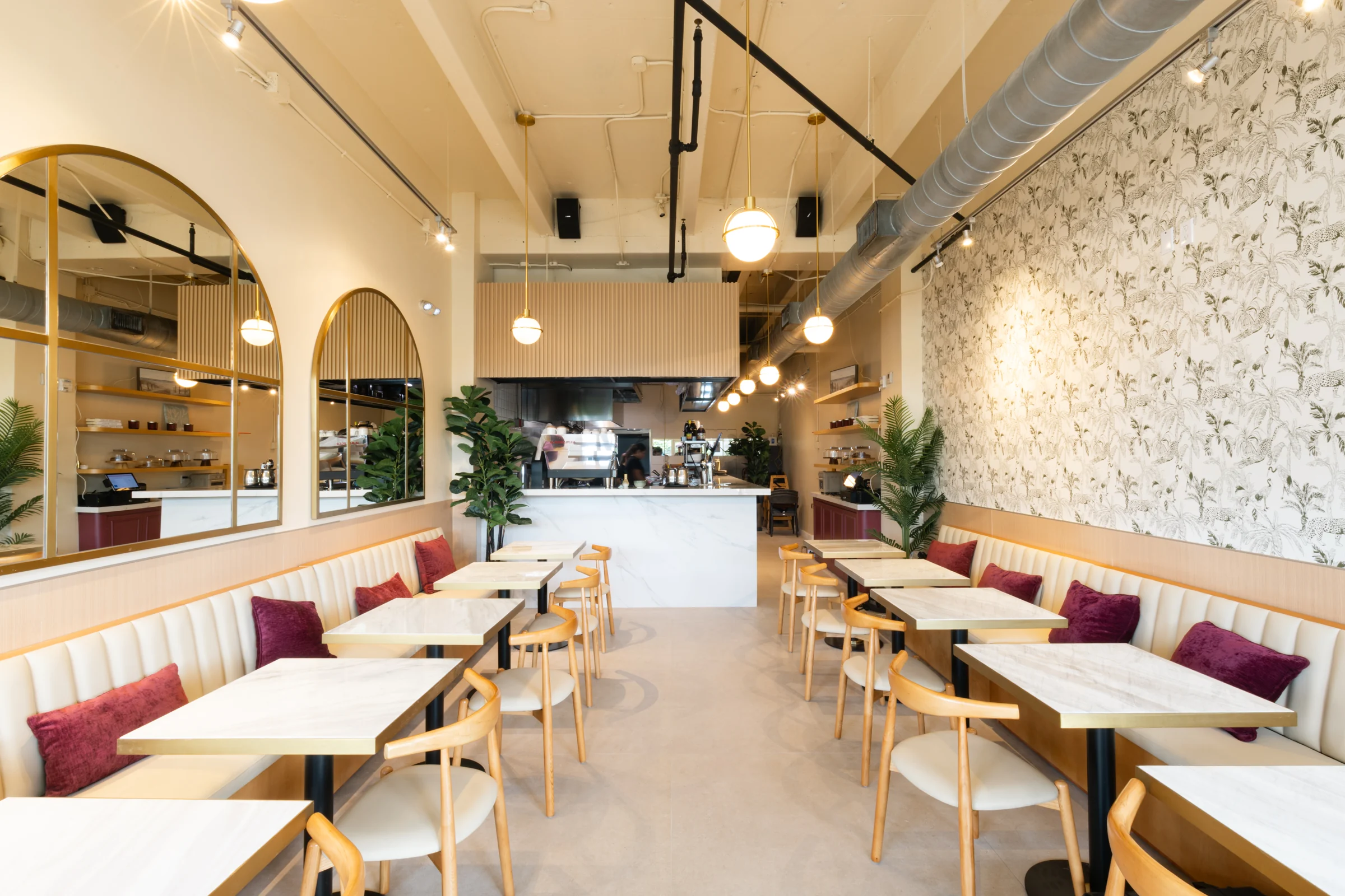 Amand Café & Bistro dining room with cream banquettes, tables and coffee bar