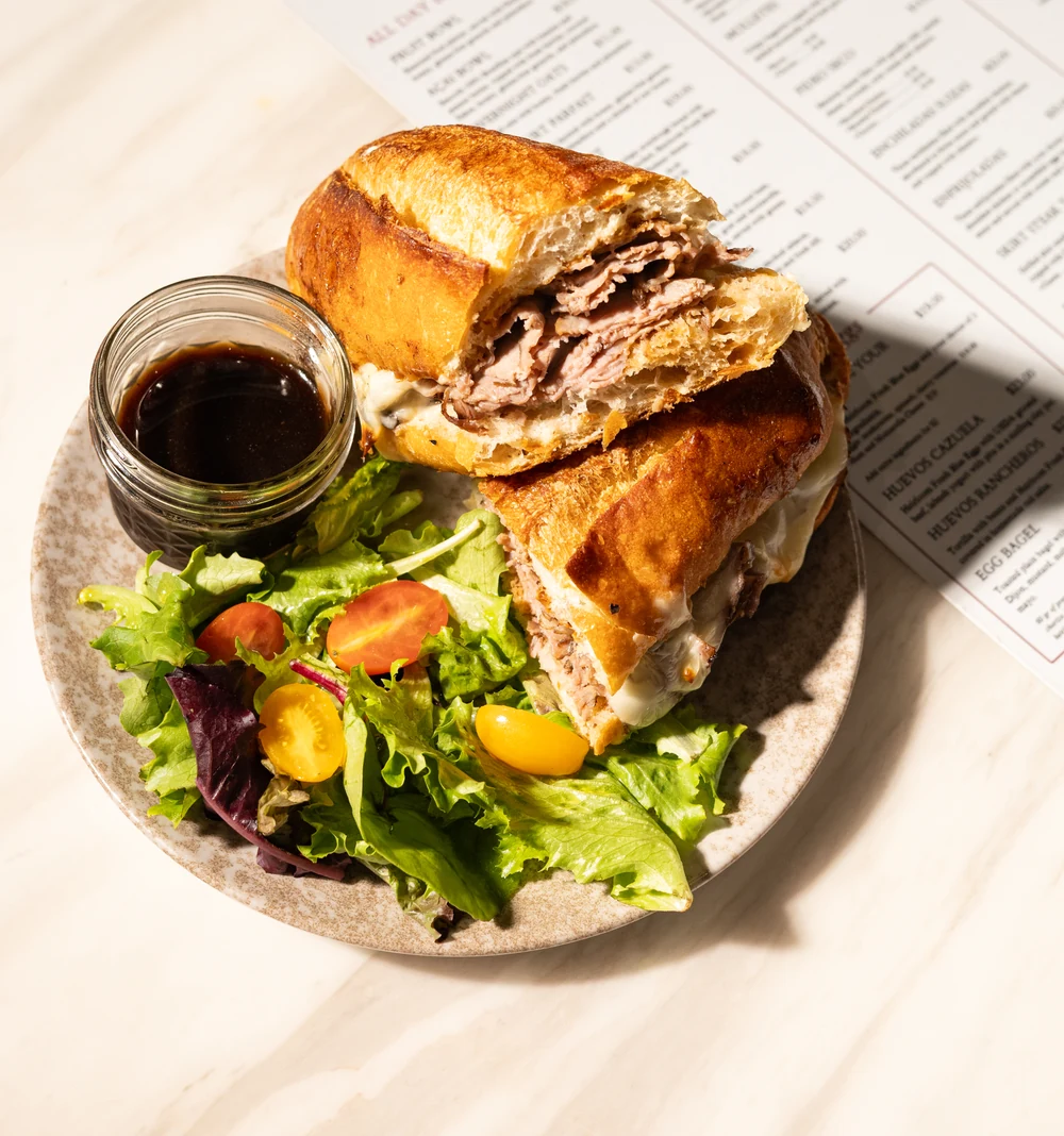 Beef sandwich with salad and dipping sauce at Amand.