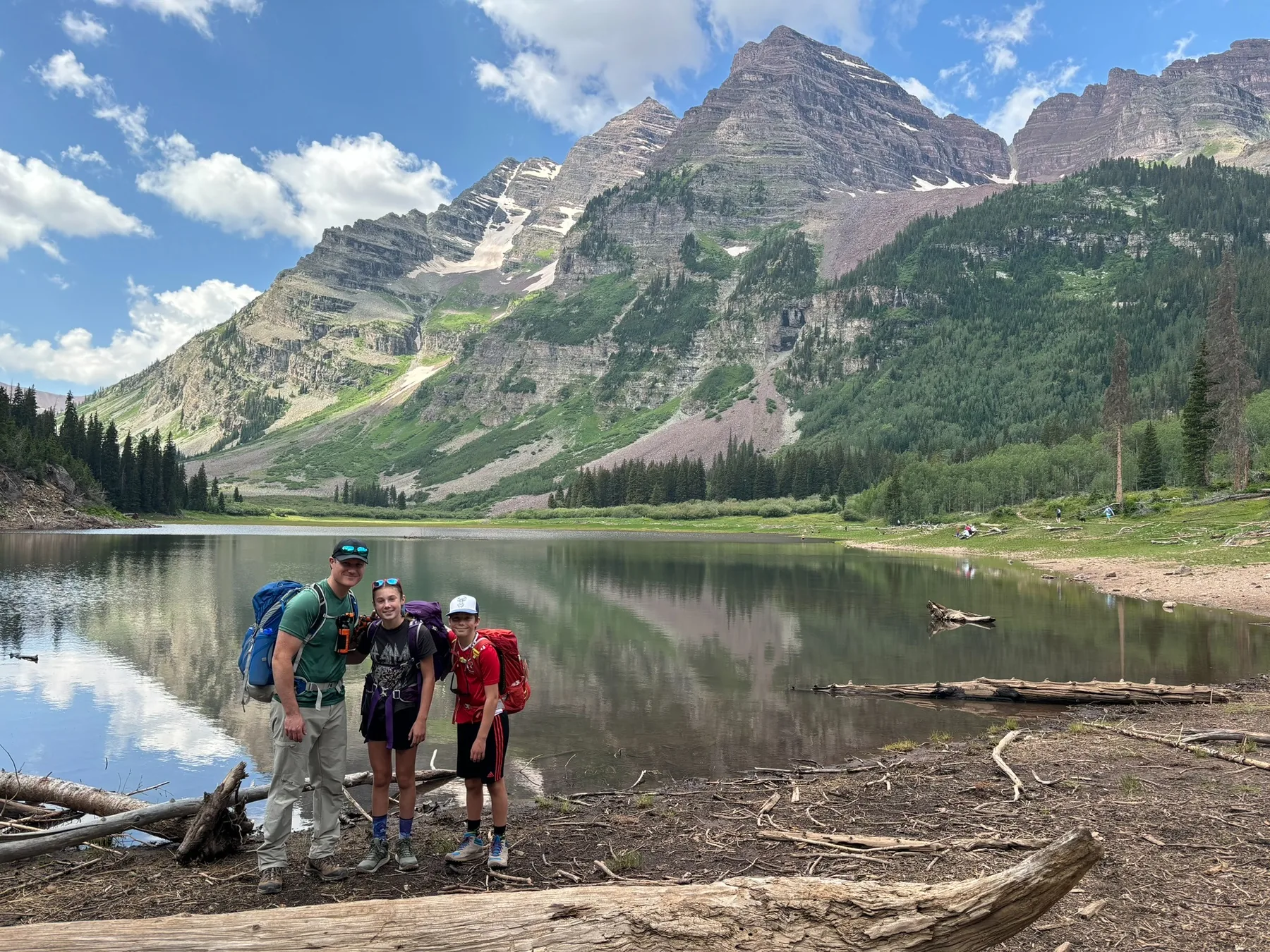 Dr. Haber and family hiking beside an alpine lake