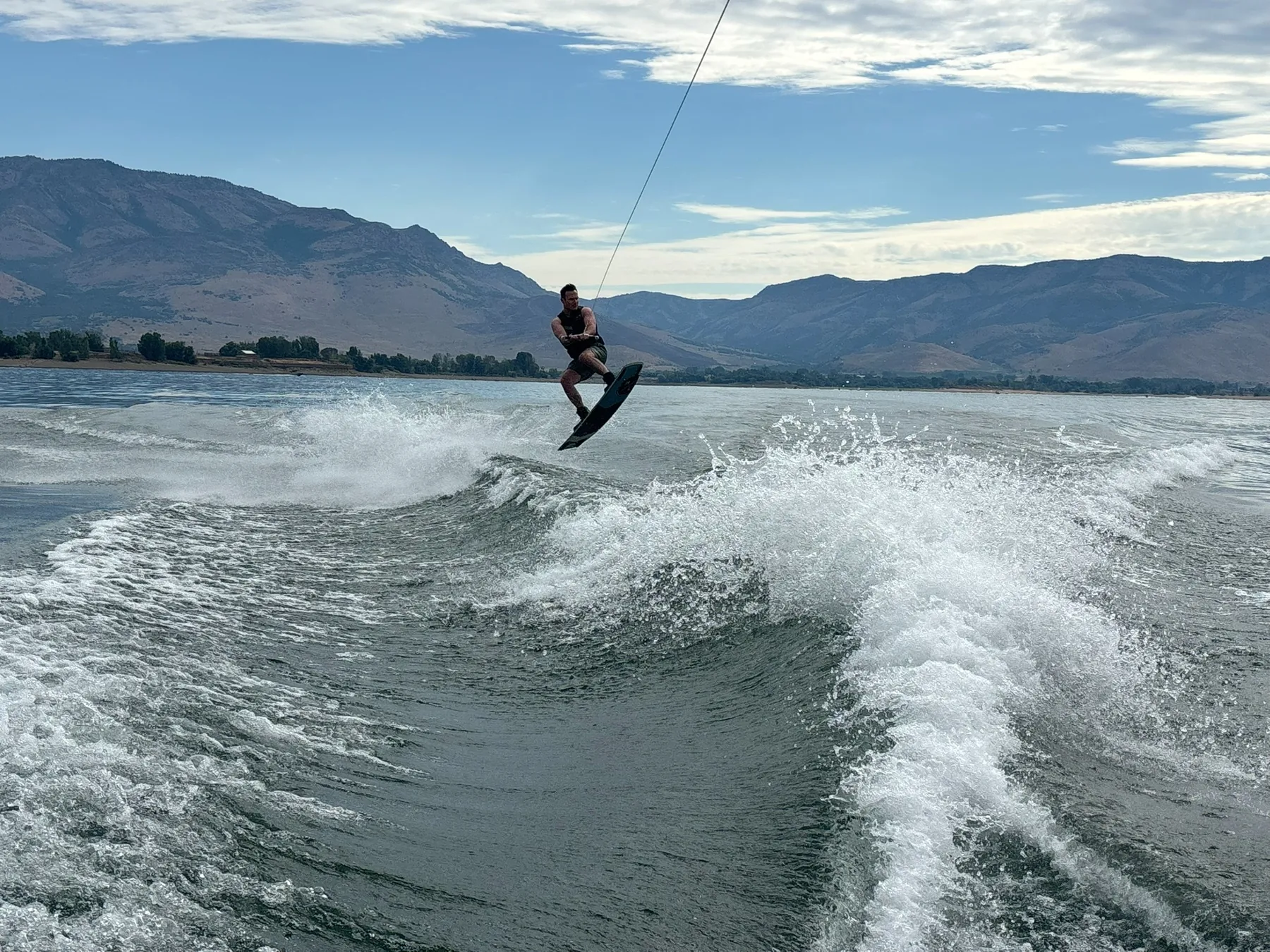 Dr. Haber wakeboarding on a mountain lake