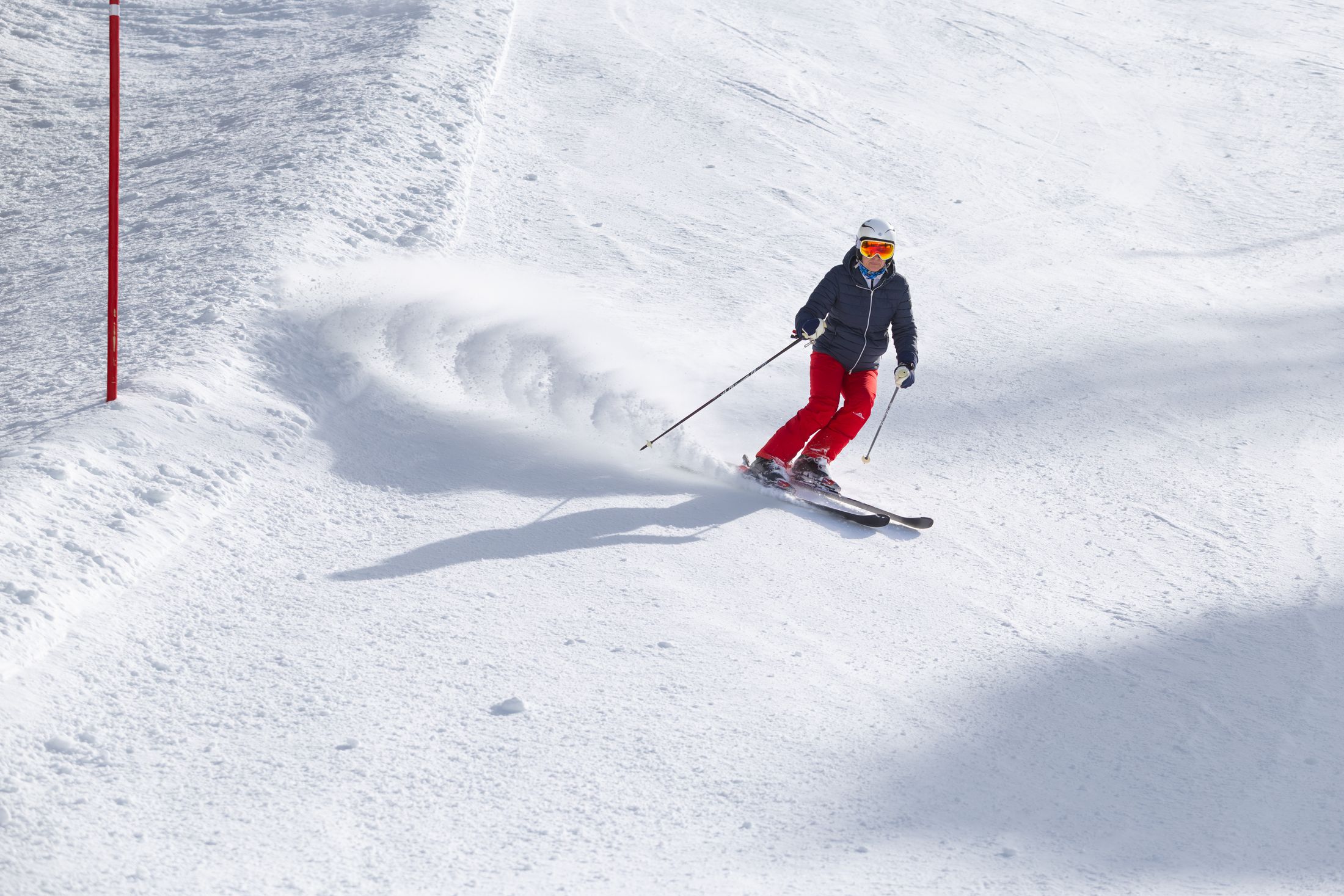 Skier carving across an alpine slope