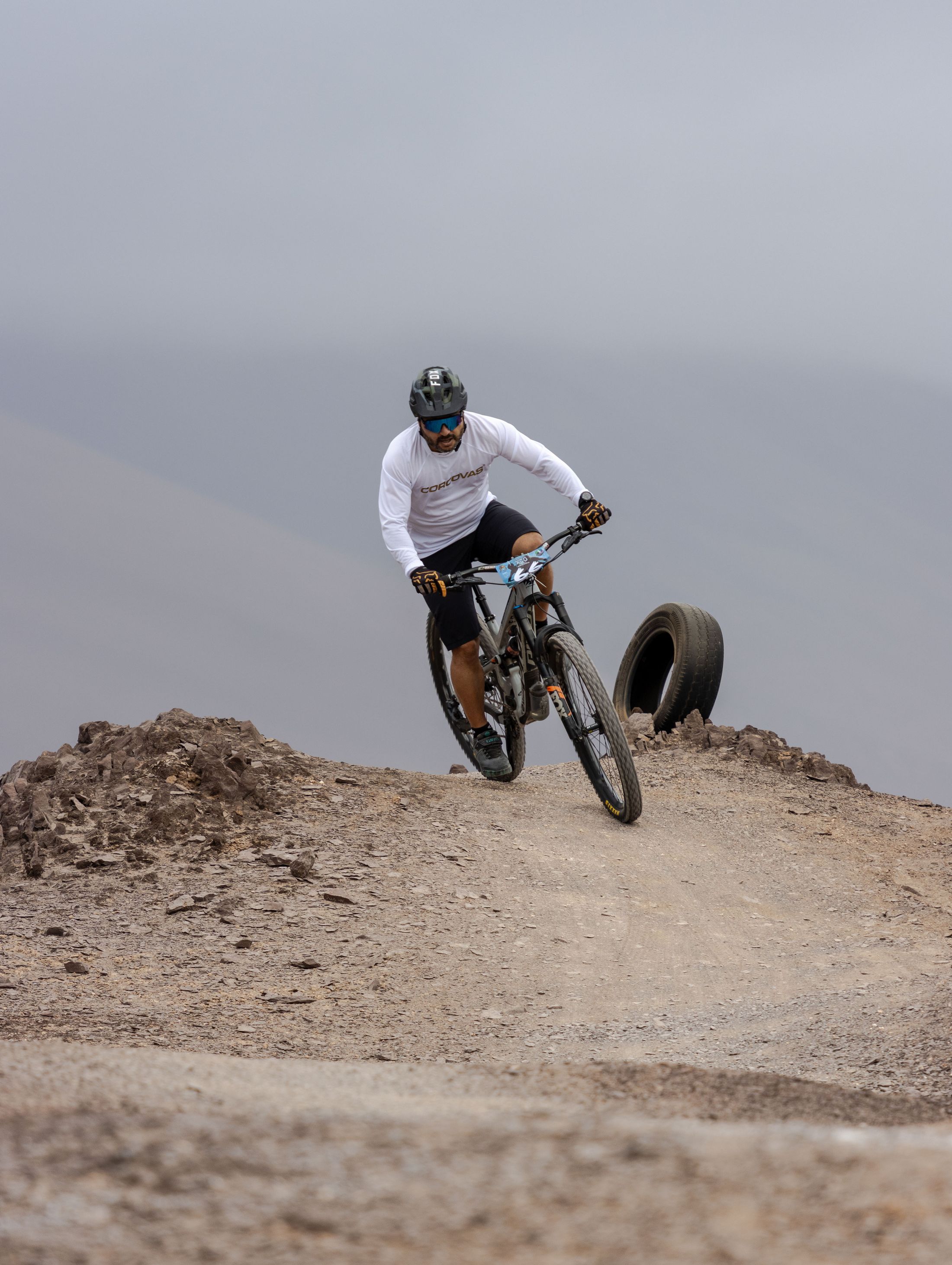 Mountain biker riding down a rocky alpine trail
