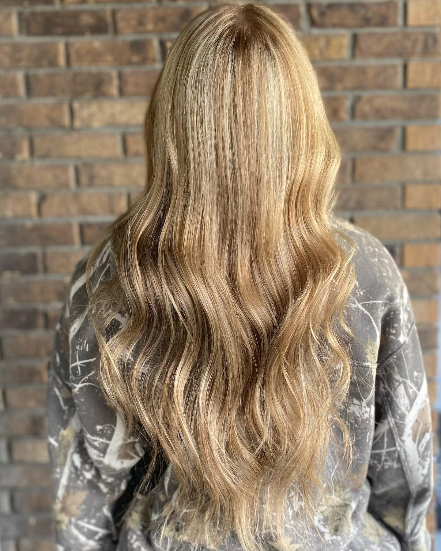 Sandy blonde highlights blended from a darker root