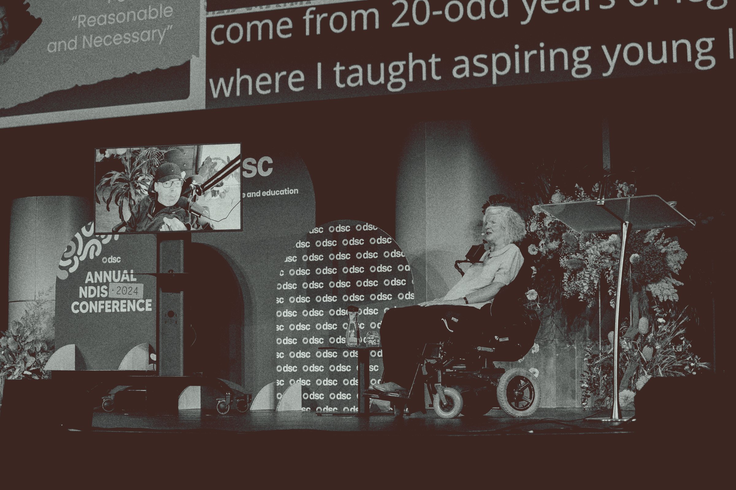 A speaker in a wheelchair on stage at the DSC Annual NDIS Conference in Sydney