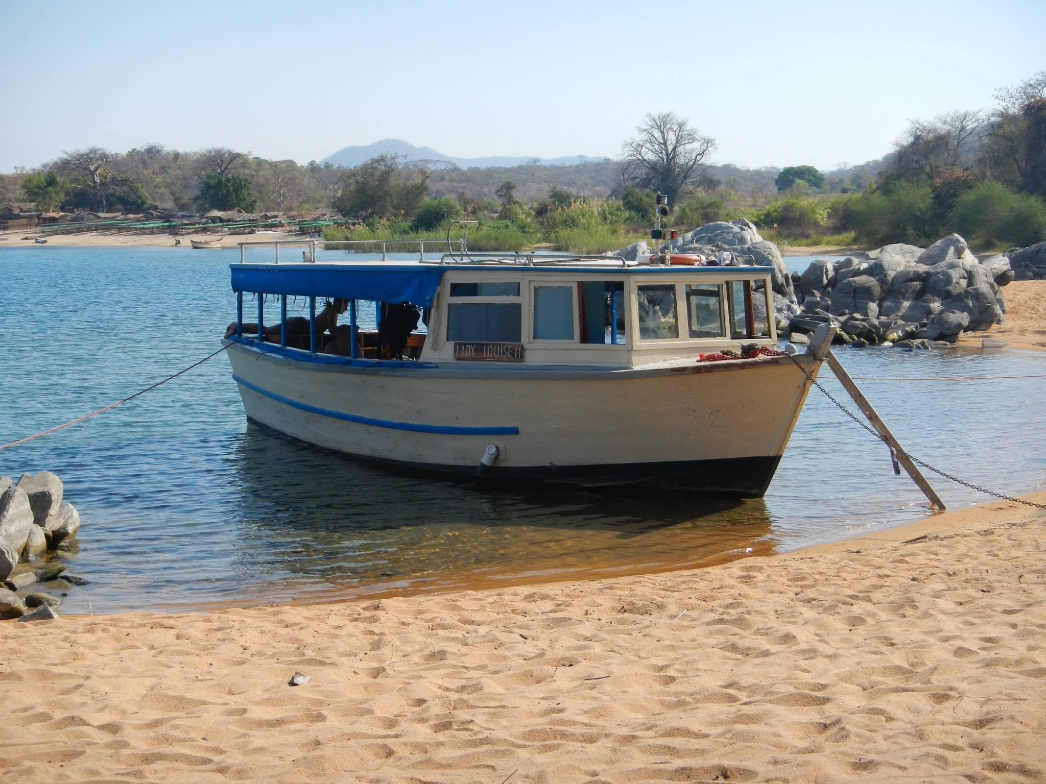 The Lady Louise, Red Zebra Lodge's boat, moored on the shore of Lake Malawi