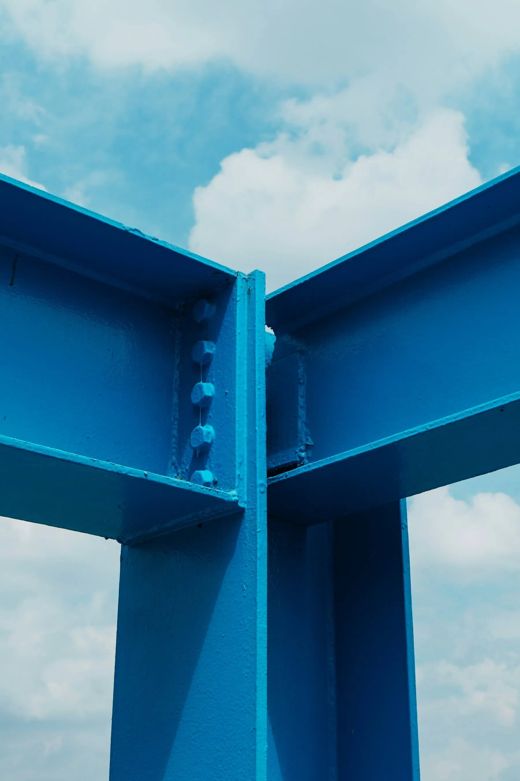 Close up of blue structural steel against the sky