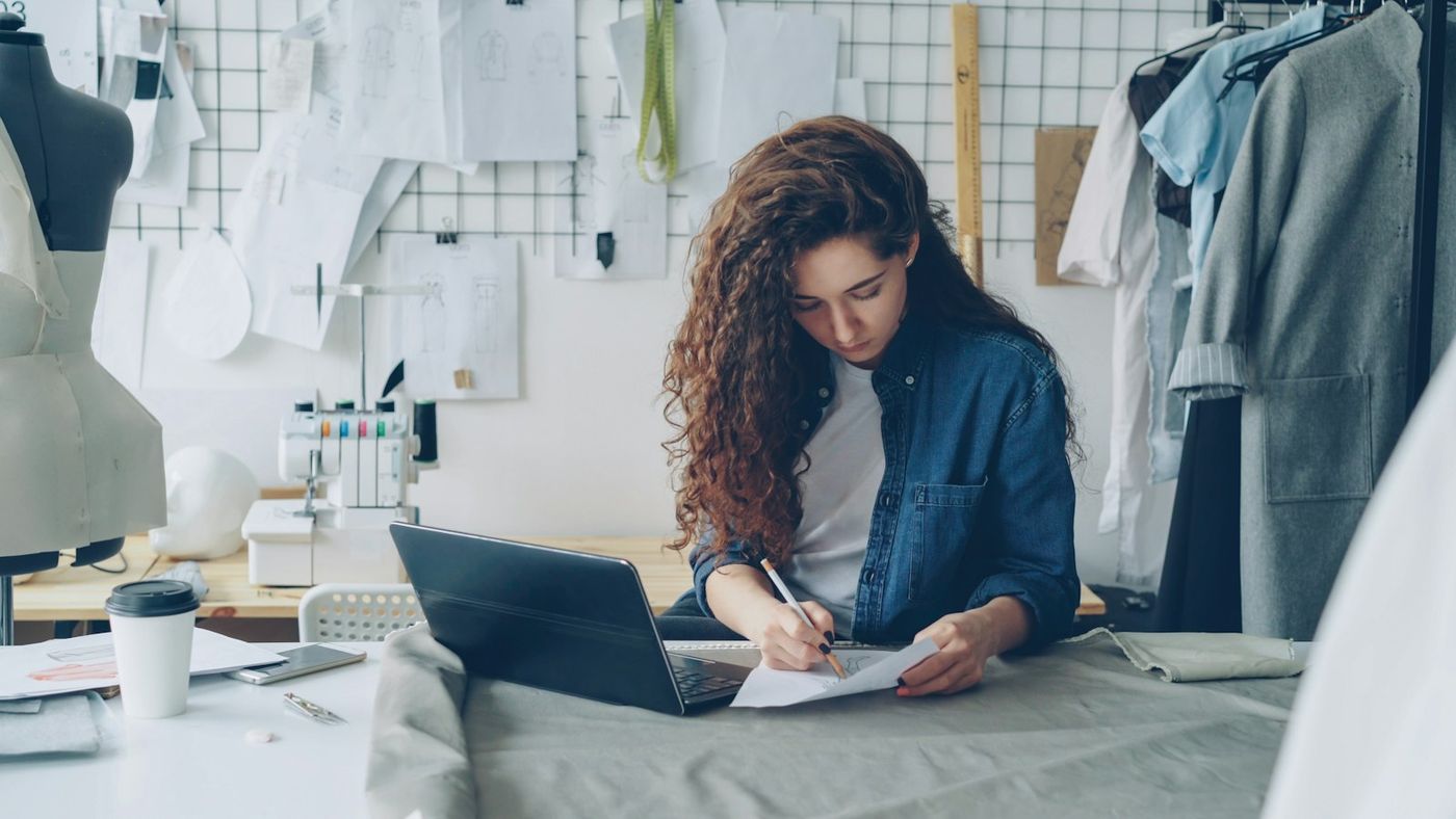 Fashion designer sketching at her studio desk