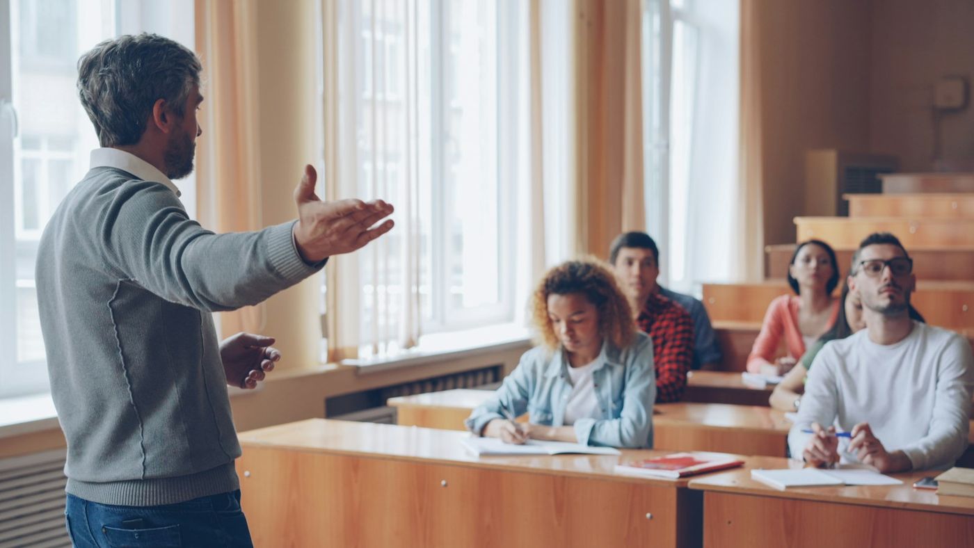 Professor lecturing to students in a lecture hall
