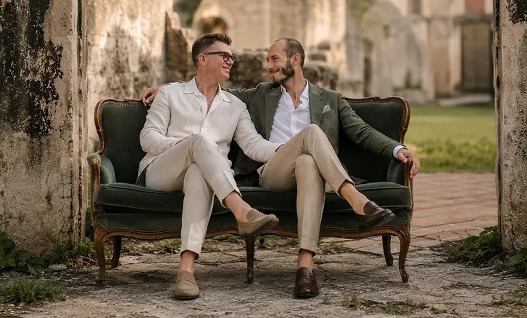 Jesse James Ferrell and Mike Calva on a green velvet sofa