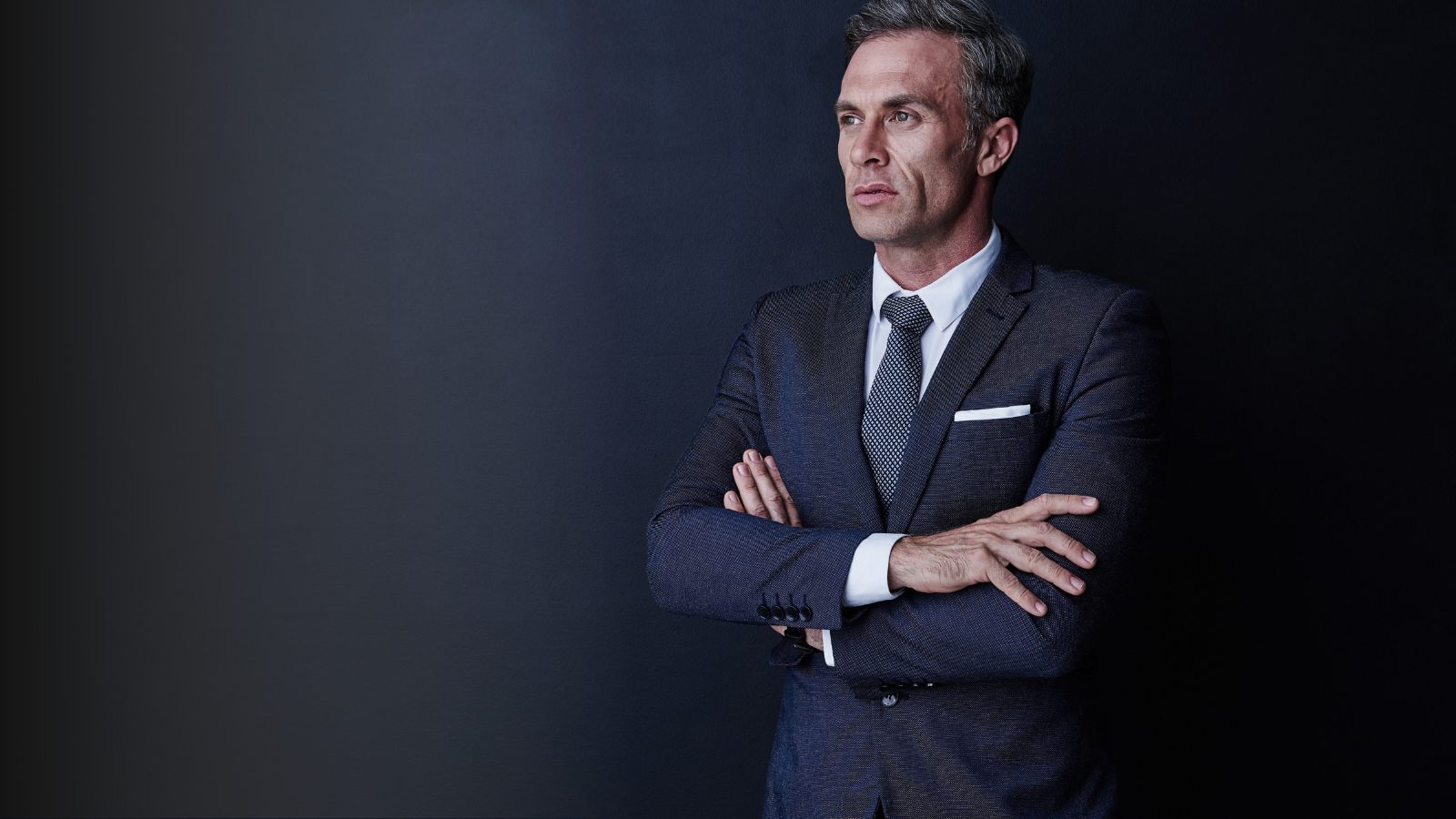 Senior executive with arms crossed