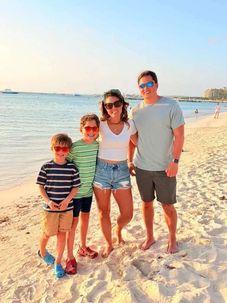 Taylor, the maker of Lifeboard, and family on a beach at sunset
