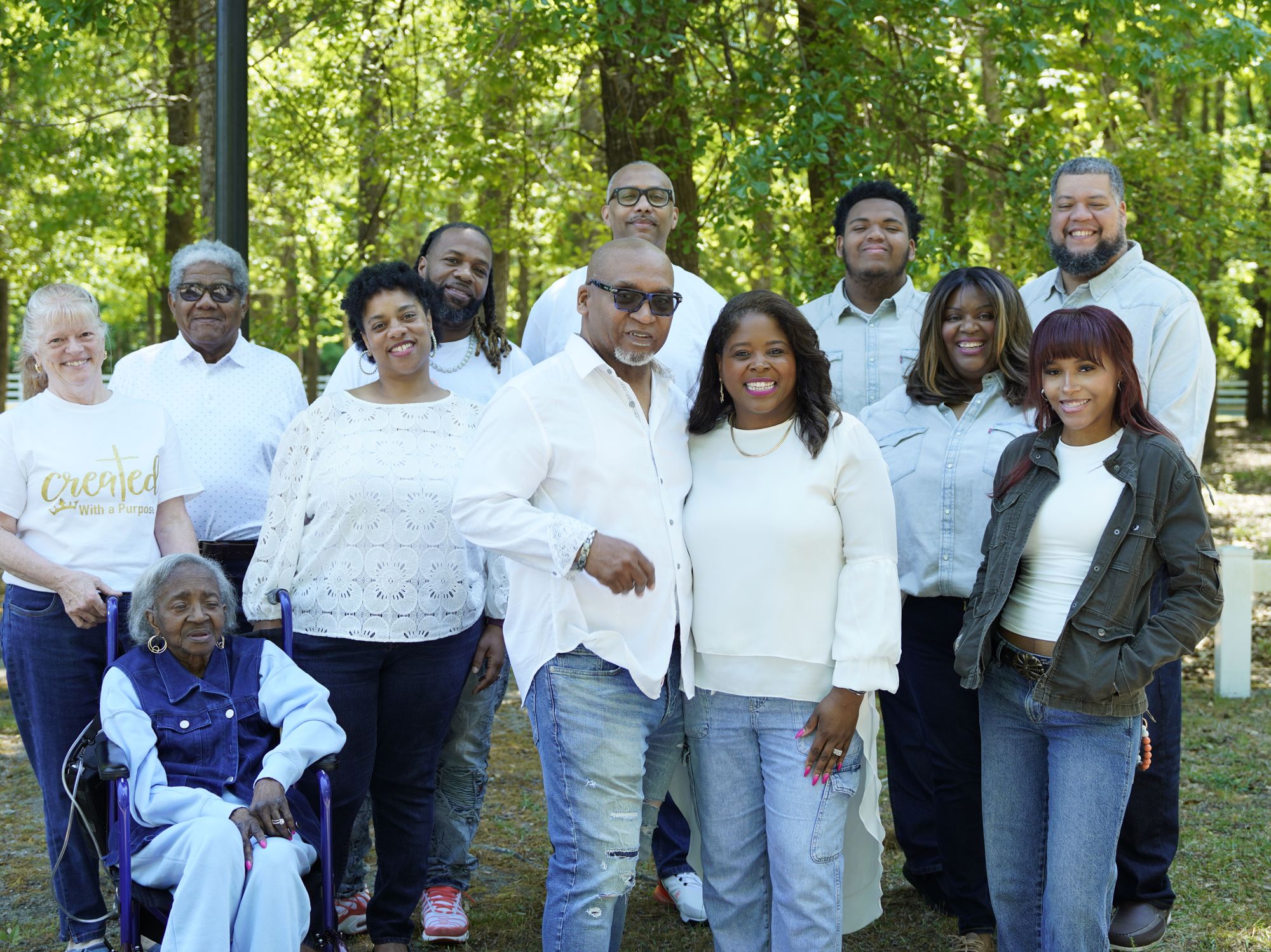 The Myrtle Tree Ministries church family gathered outdoors among the trees