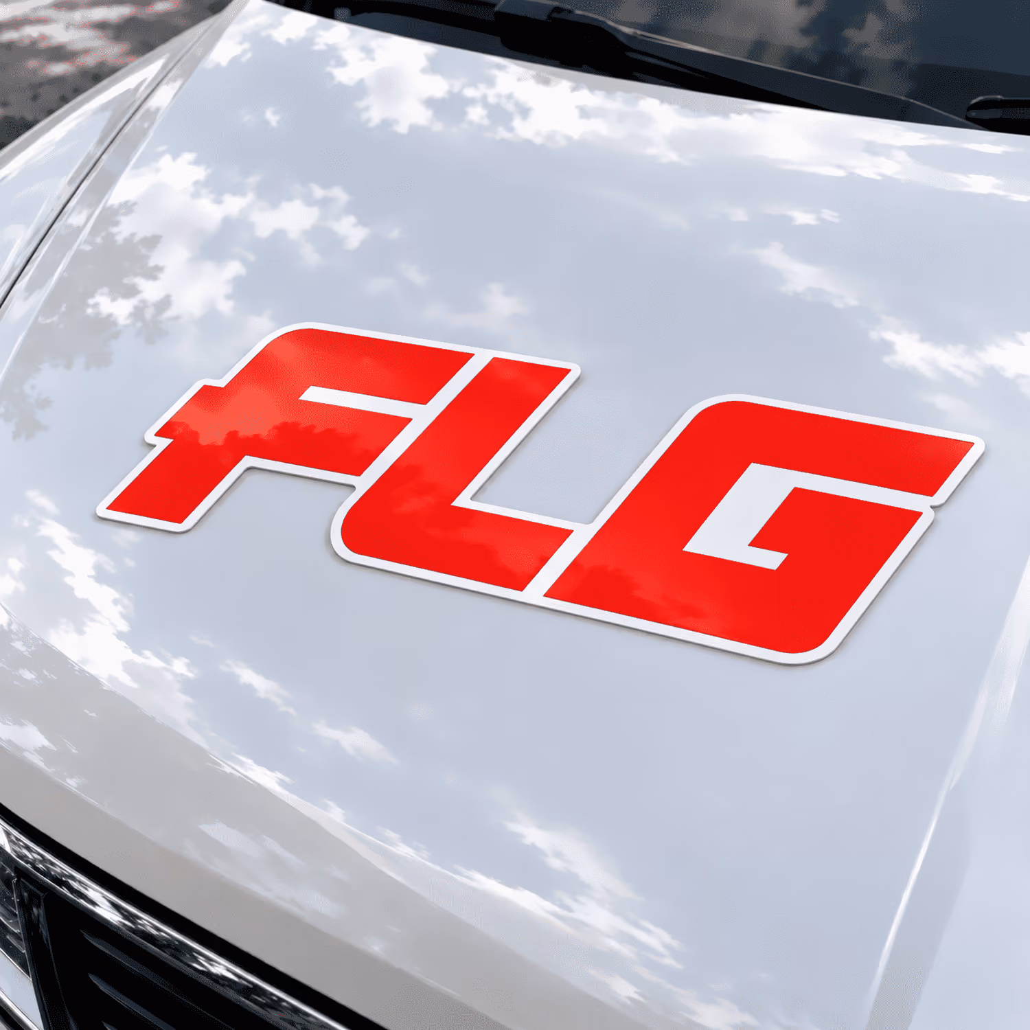 FLG logo sign fitted on a white van bonnet