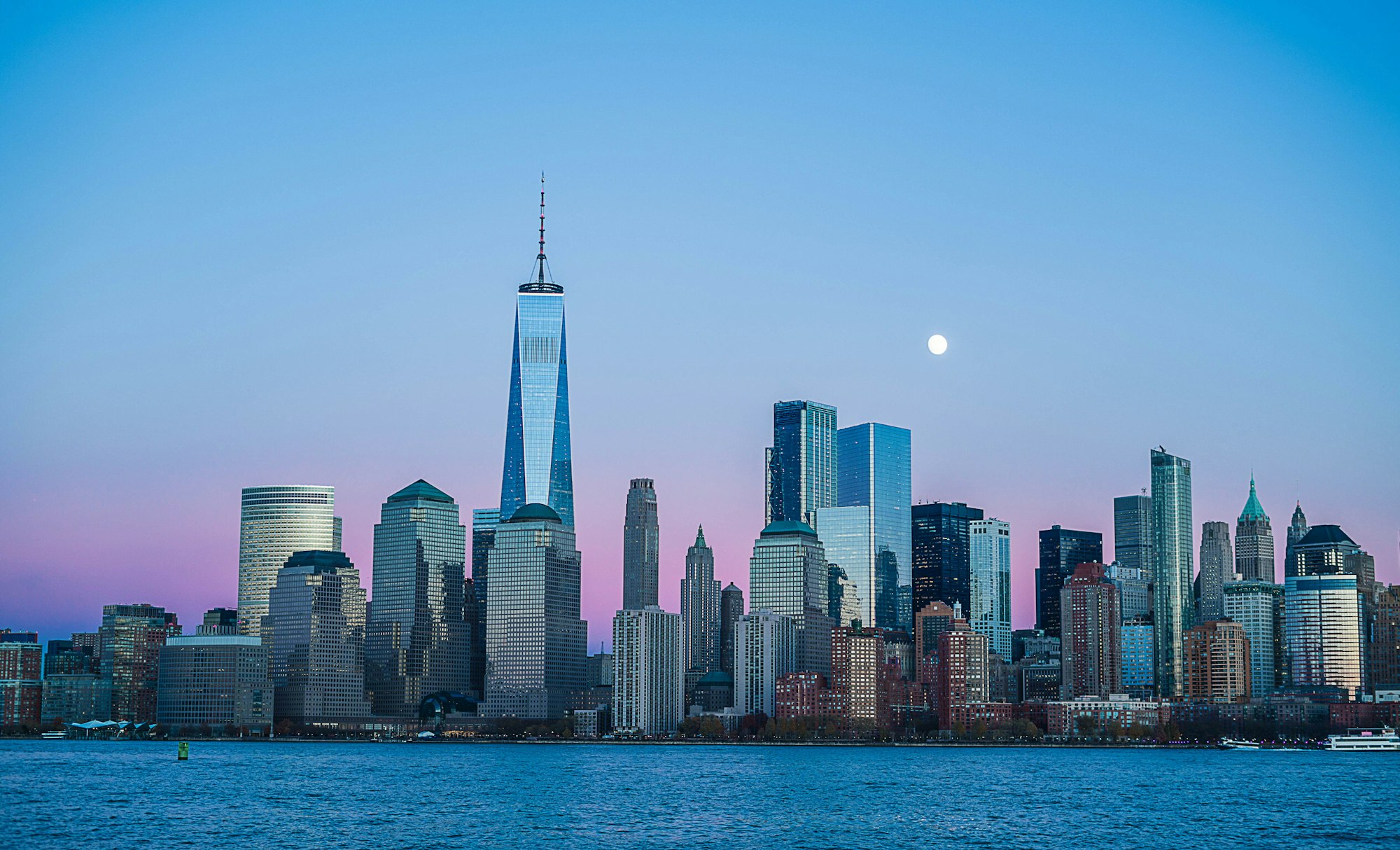 Lower Manhattan skyline at dusk seen across the river