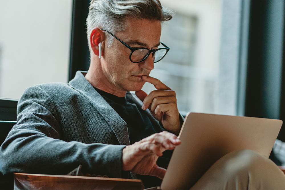 Senior executive reviewing his LinkedIn profile