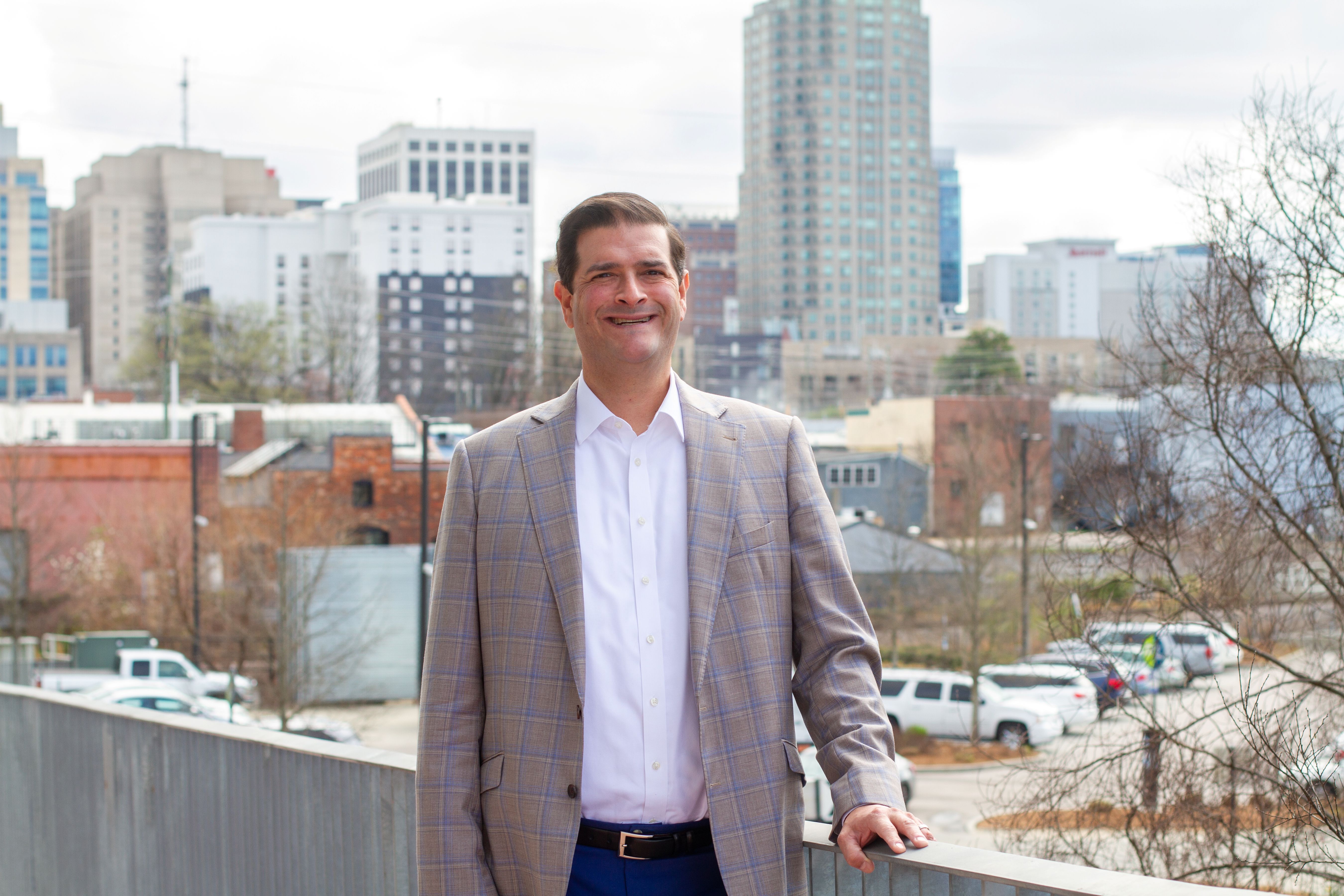 Khaner Walker standing on a walkway overlooking downtown Raleigh