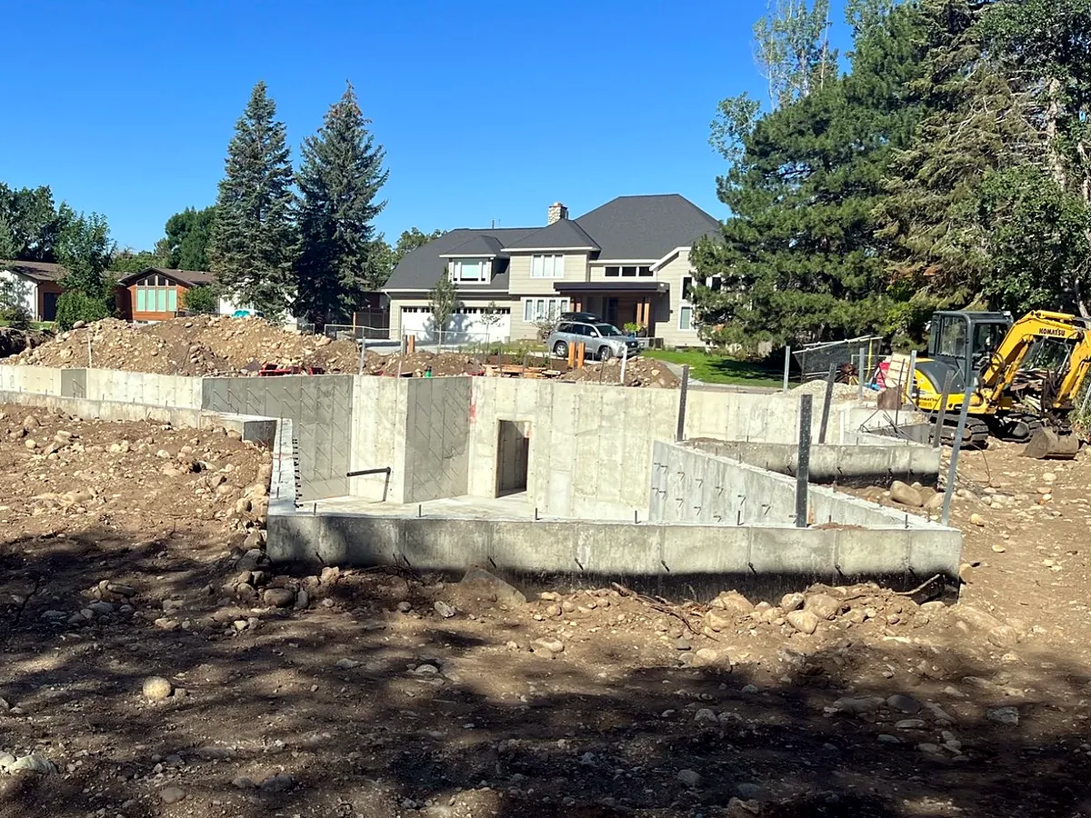 Poured basement foundation walls on a cleared residential lot with a mini excavator, Ritz Excavation & Demolition