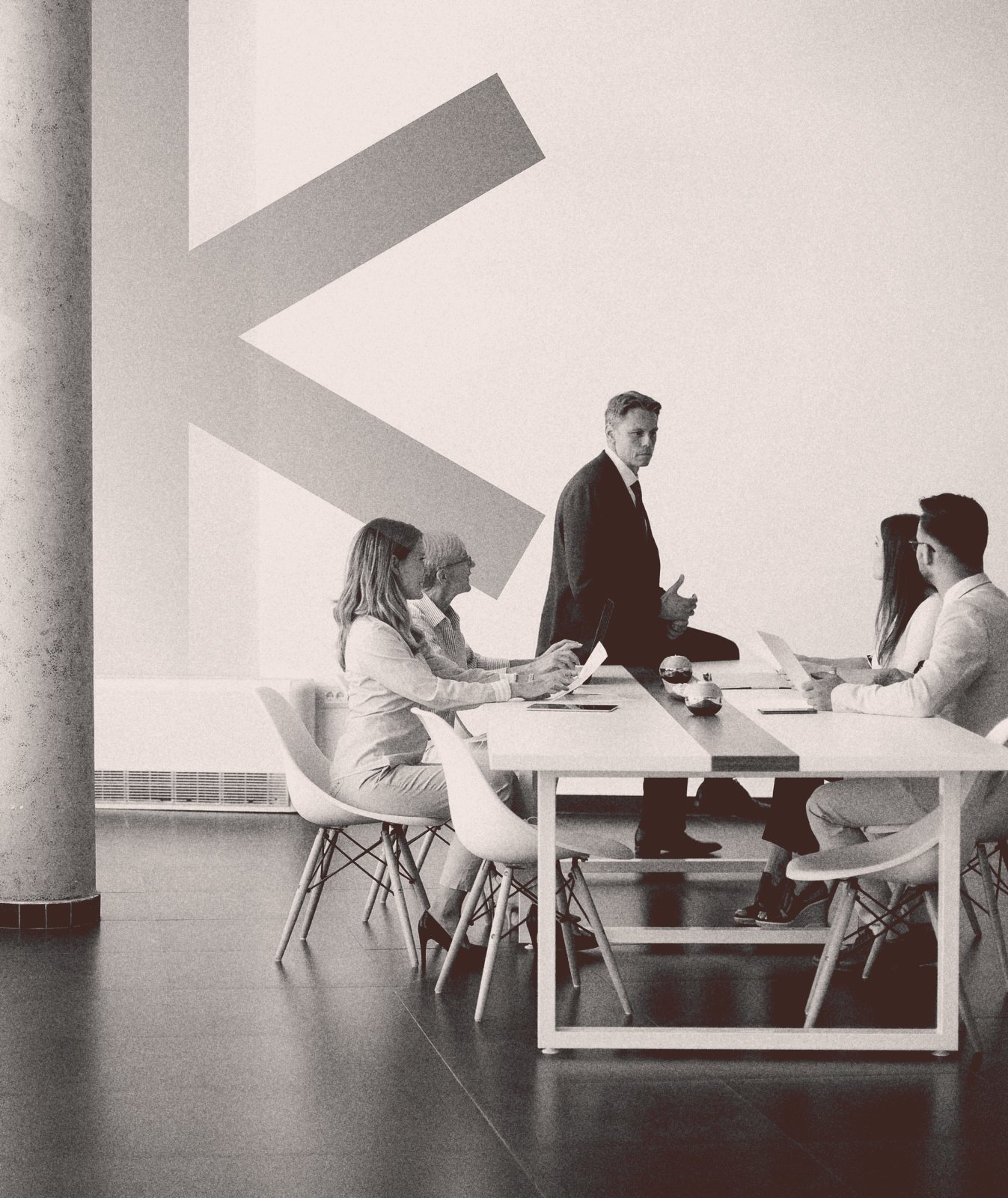A business meeting with a large K graphic from the DekkoSecure identity