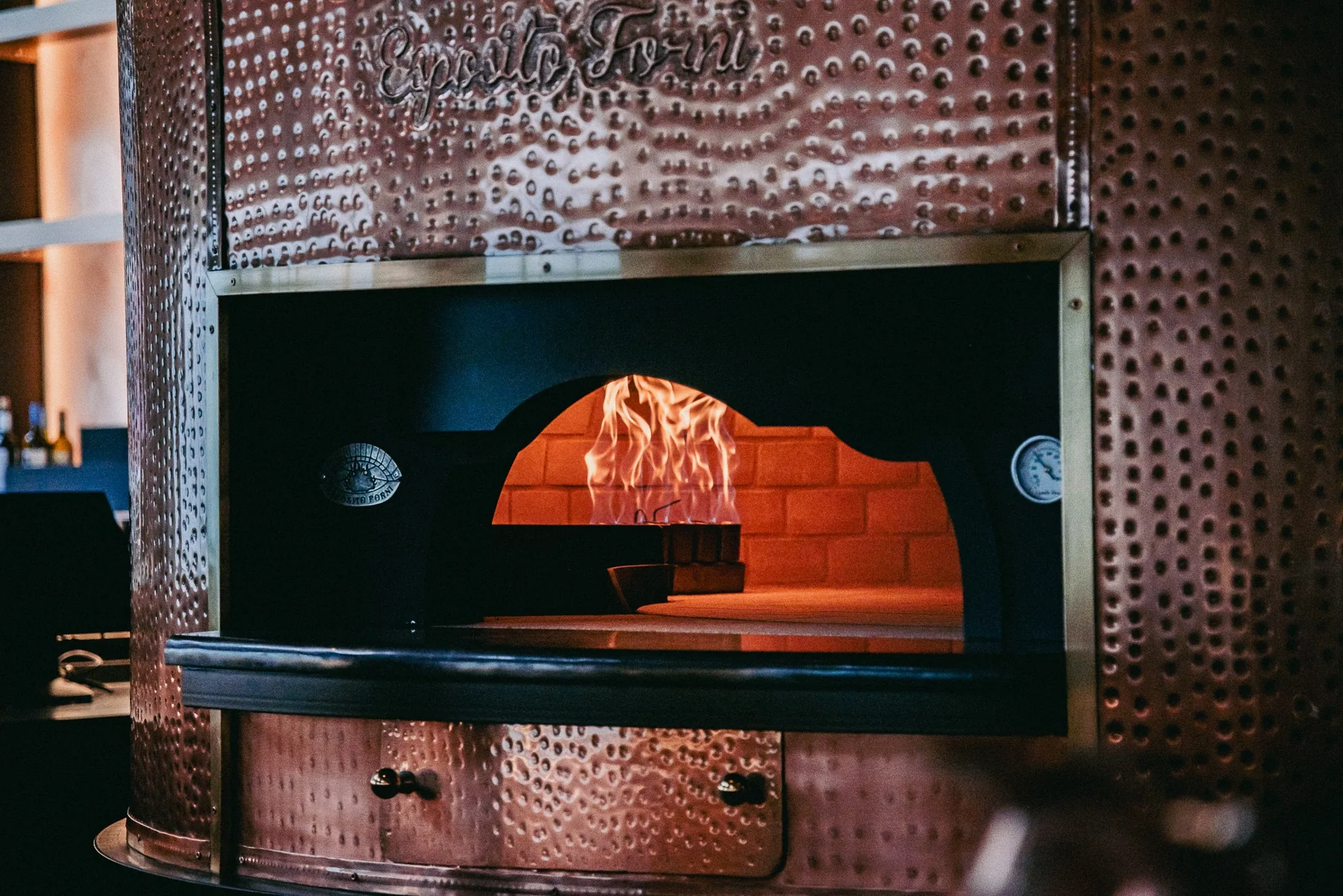 Bazaar's copper wood-fired oven and beautifully set tables