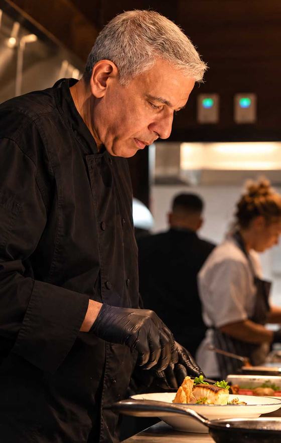 Chef Tarek Thoma plating in the Bazaar kitchen