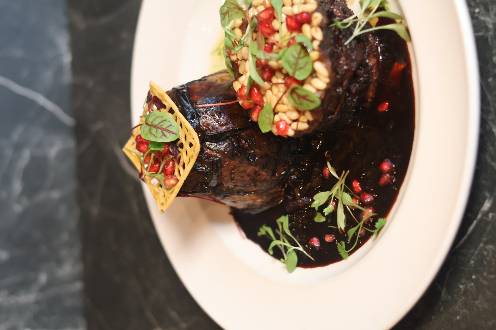 Lamb Shoulder Makloubeh with pine nuts and pomegranate at Bazaar
