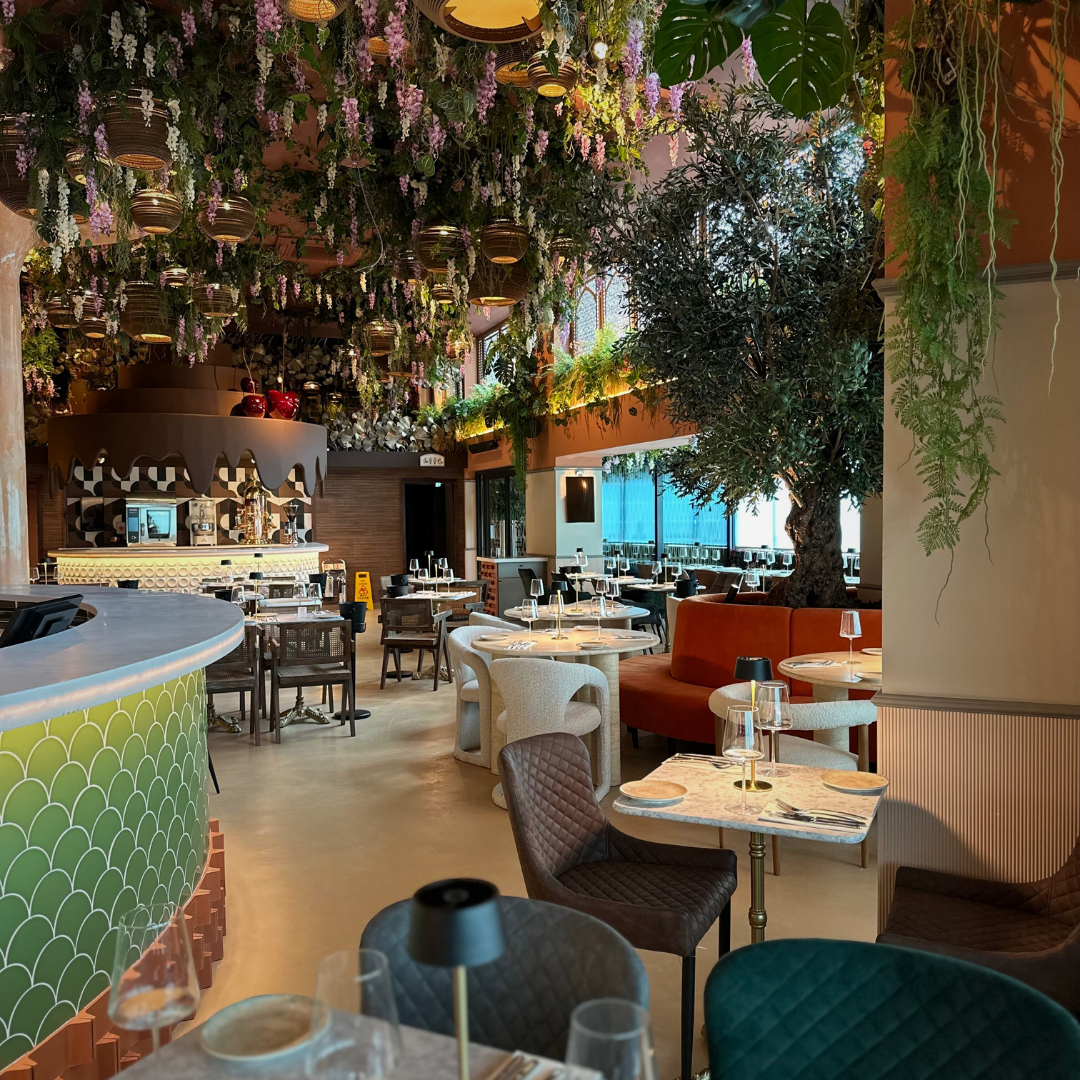 The Bazaar dining room with its green-tiled bar and hanging flowers