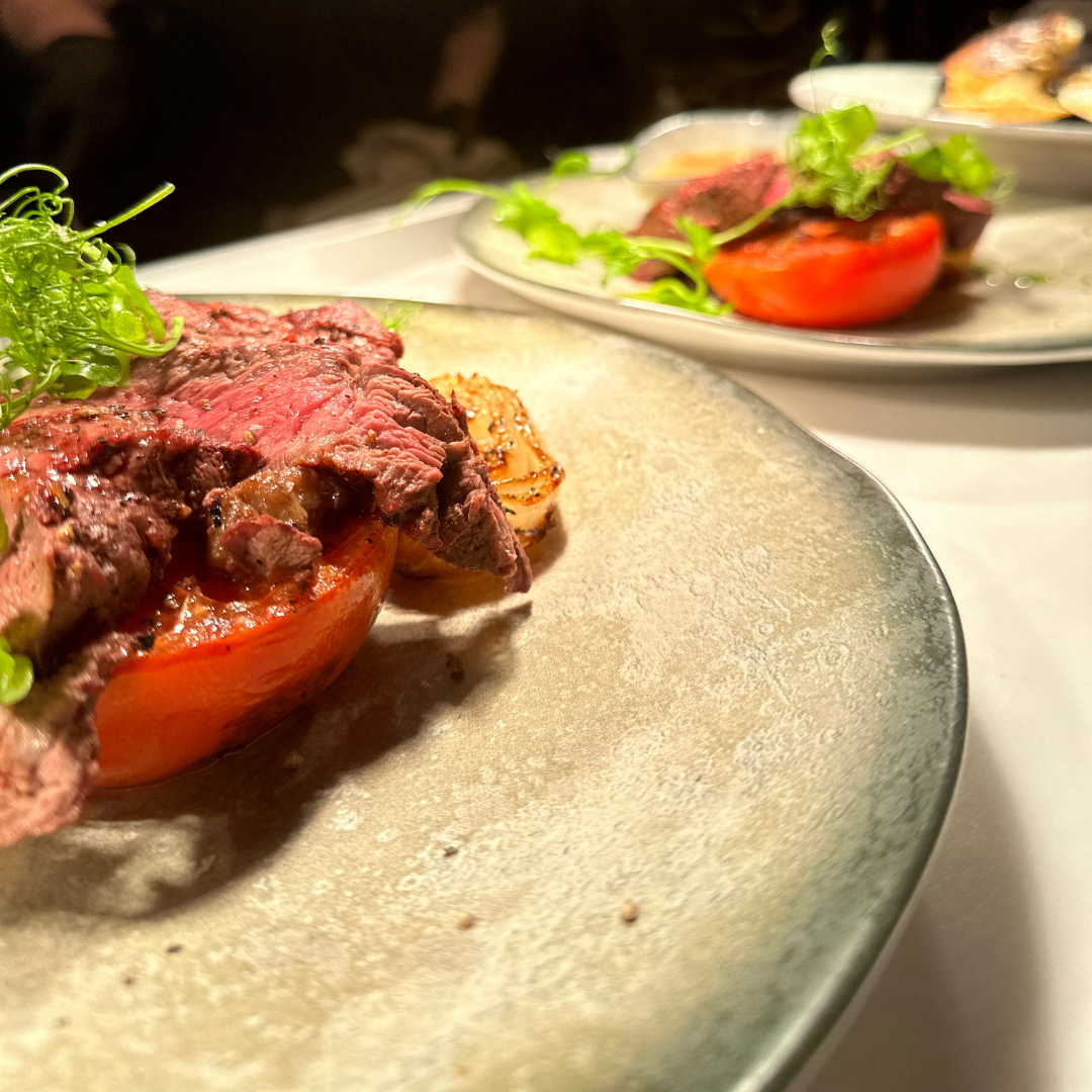 Sliced steak plated at Bazaar