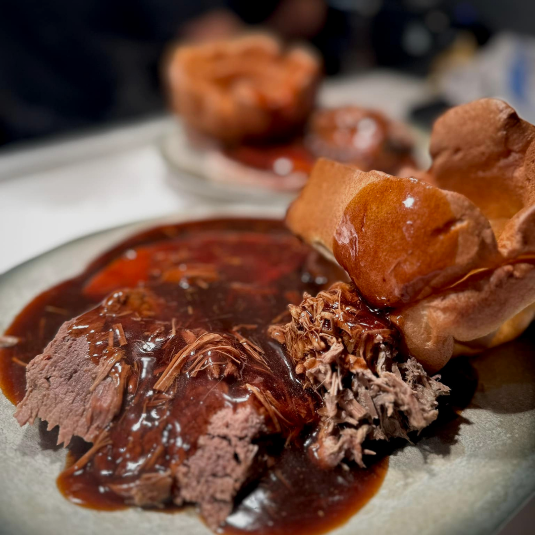 Roast beef with gravy and Yorkshire puddings at Bazaar's Sunday lunch