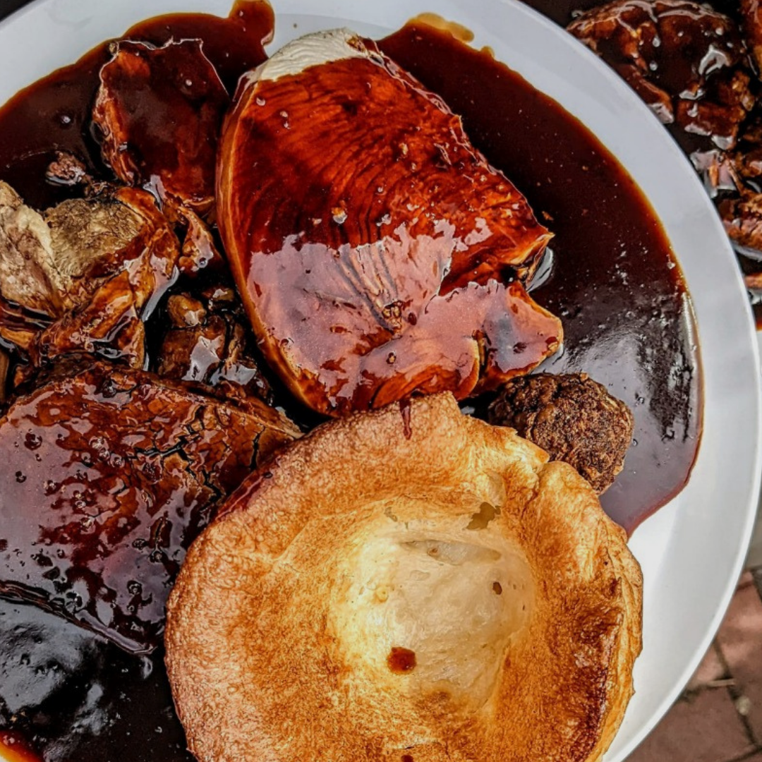A Sunday roast with rich gravy and a Yorkshire pudding