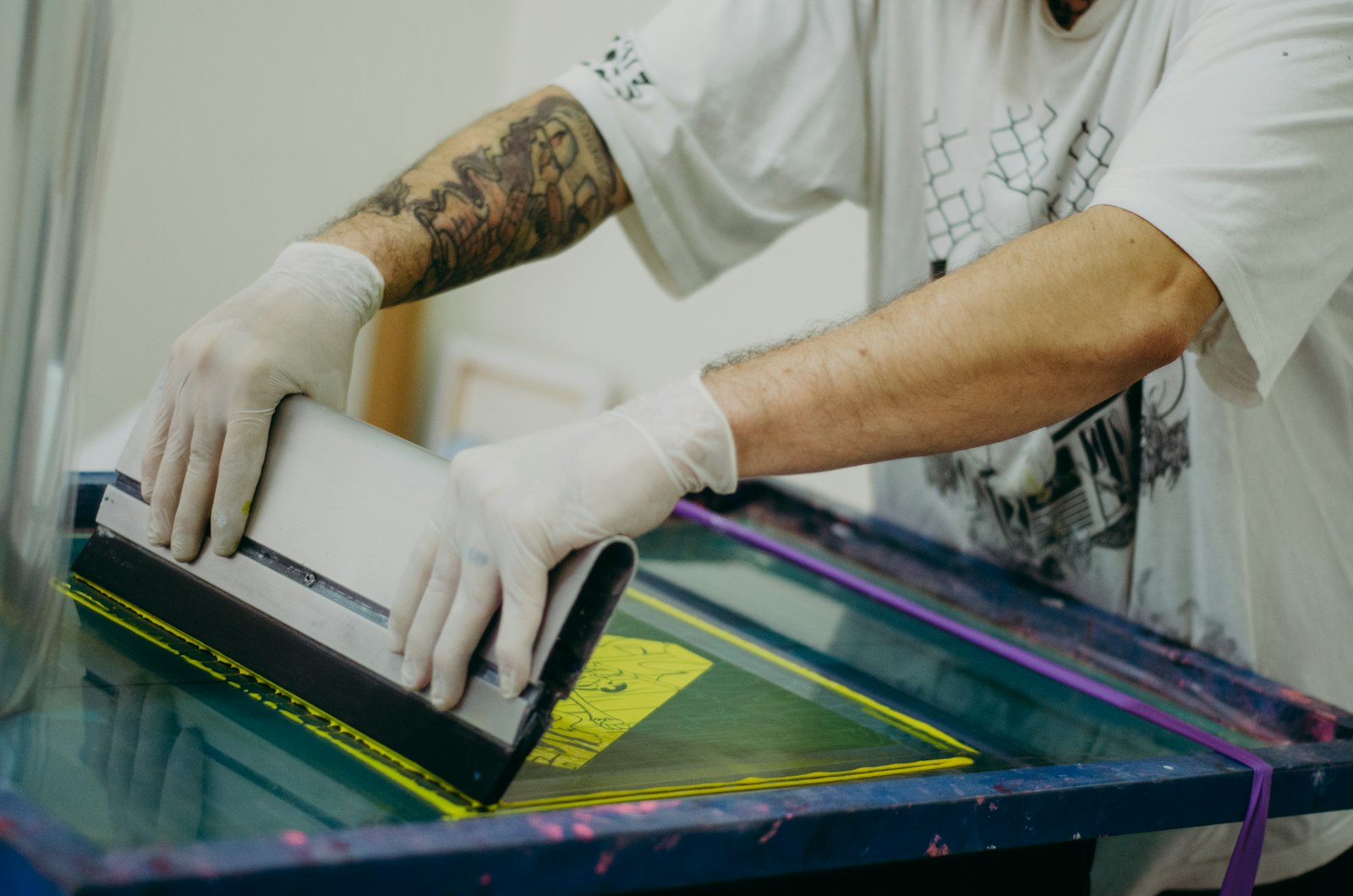 Print shop worker pressing a transfer