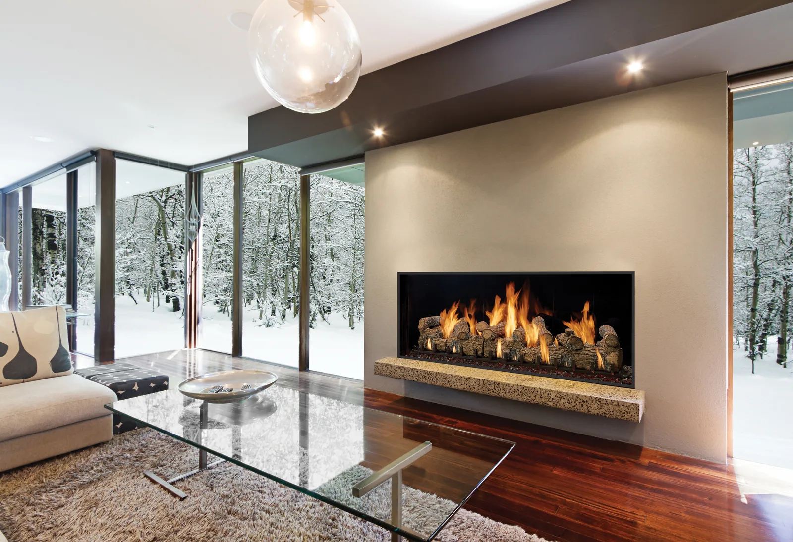 DaVinci fireplace beside snowy woodland windows