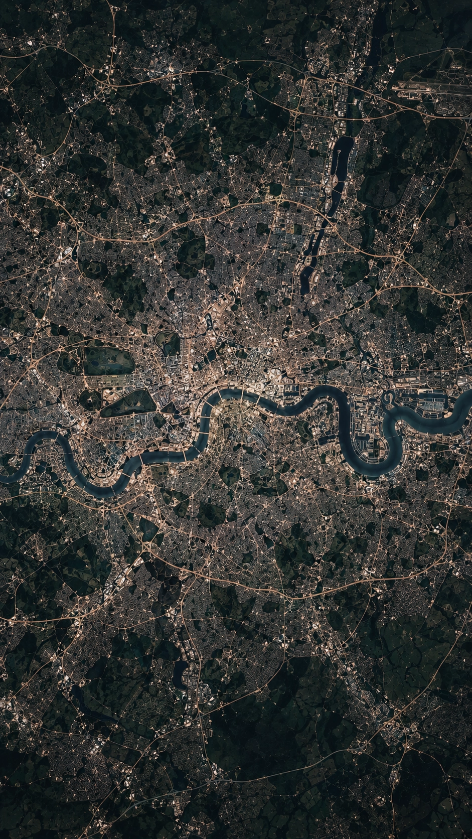 Aerial view of a large city with a winding river running from left to right across the center, surrounded by dense urban development and patches of green areas.