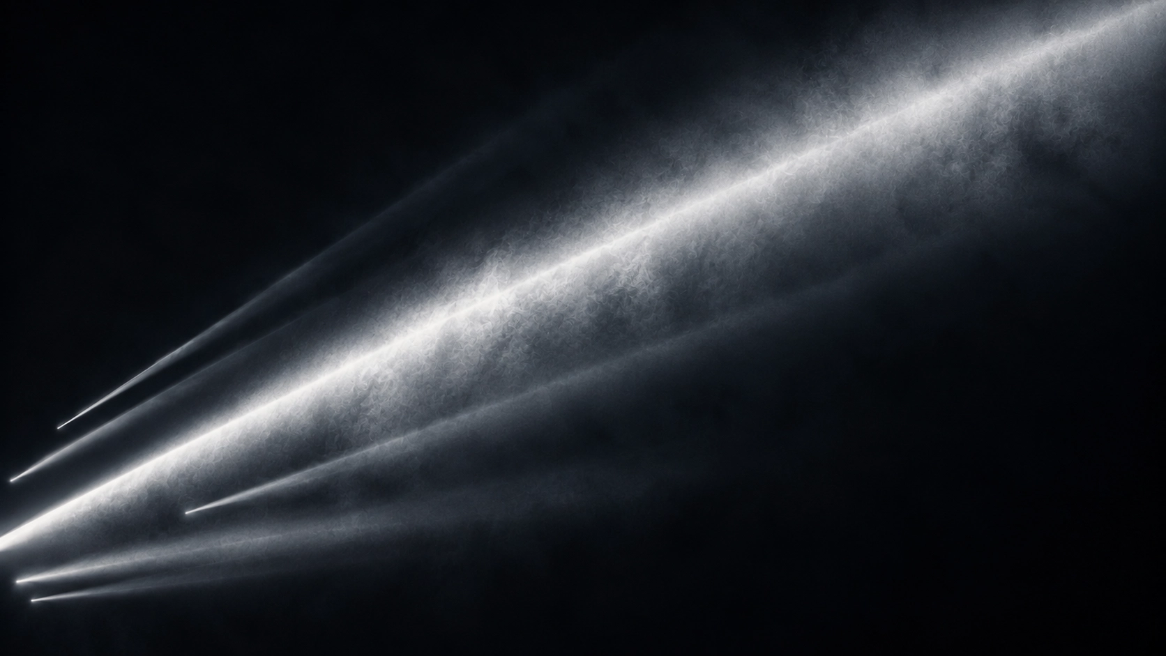 Multiple bright white beams of light shining diagonally from left to right through a dark smoky or misty background.