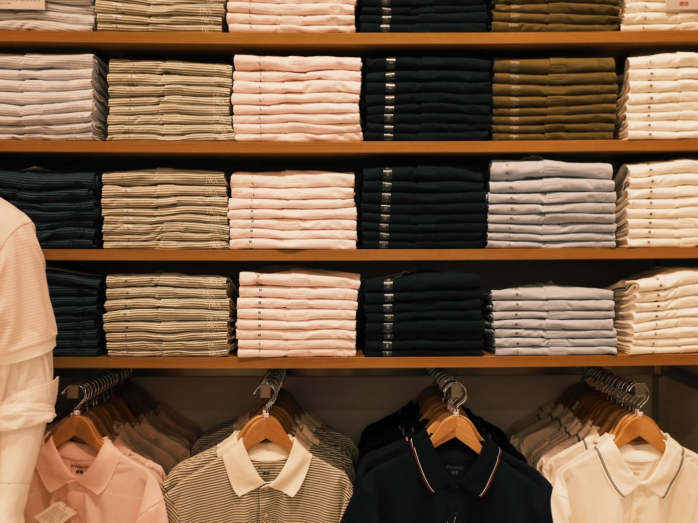 Neatly folded t-shirts stacked on shelves