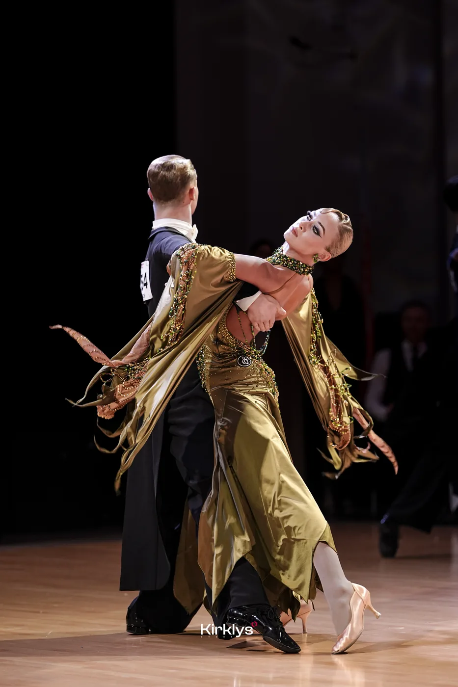 An expressive ballroom partnership in a gold gown, Jurmala 2025.