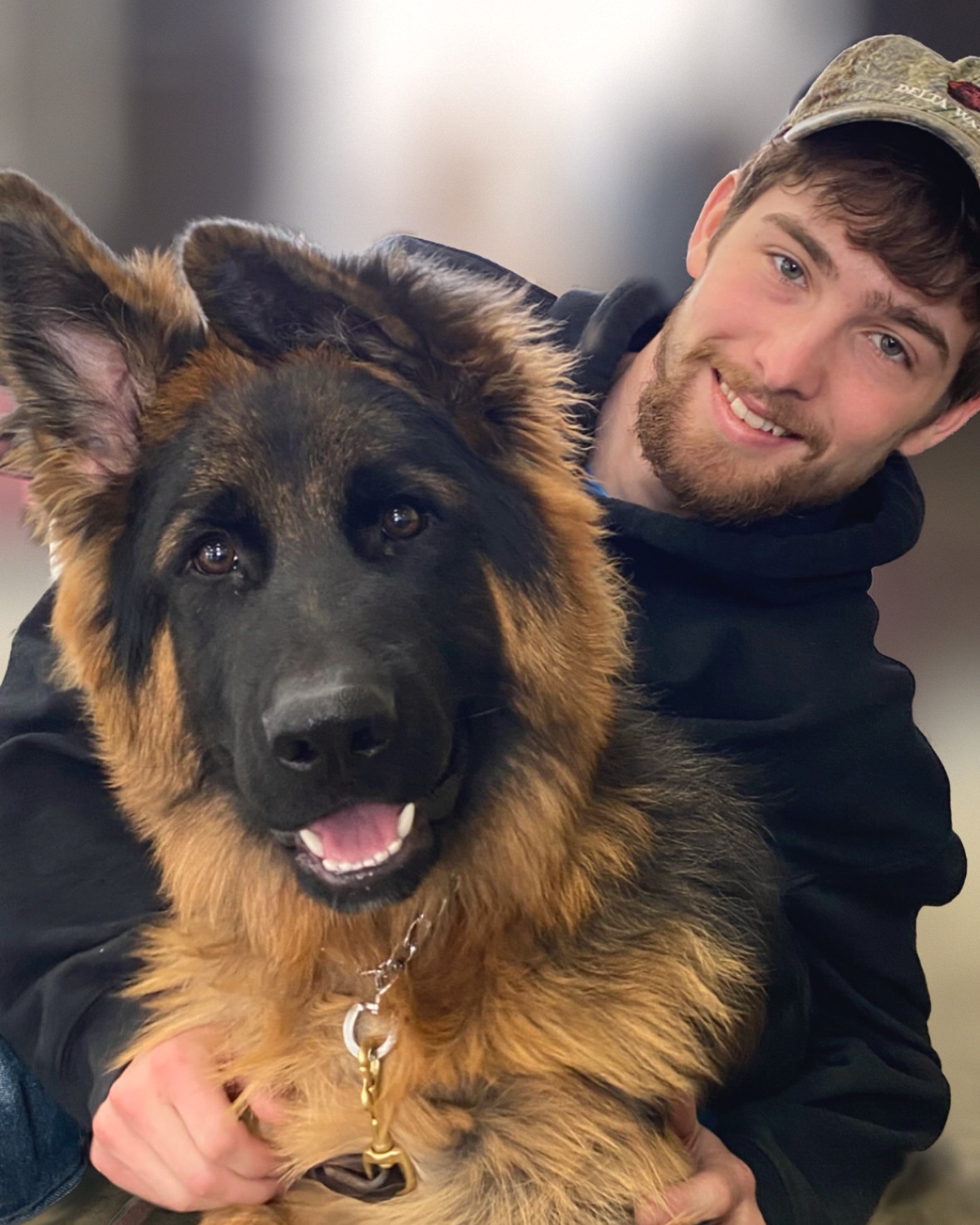 Jason Lareau of K9 Connections with a happy German Shepherd puppy