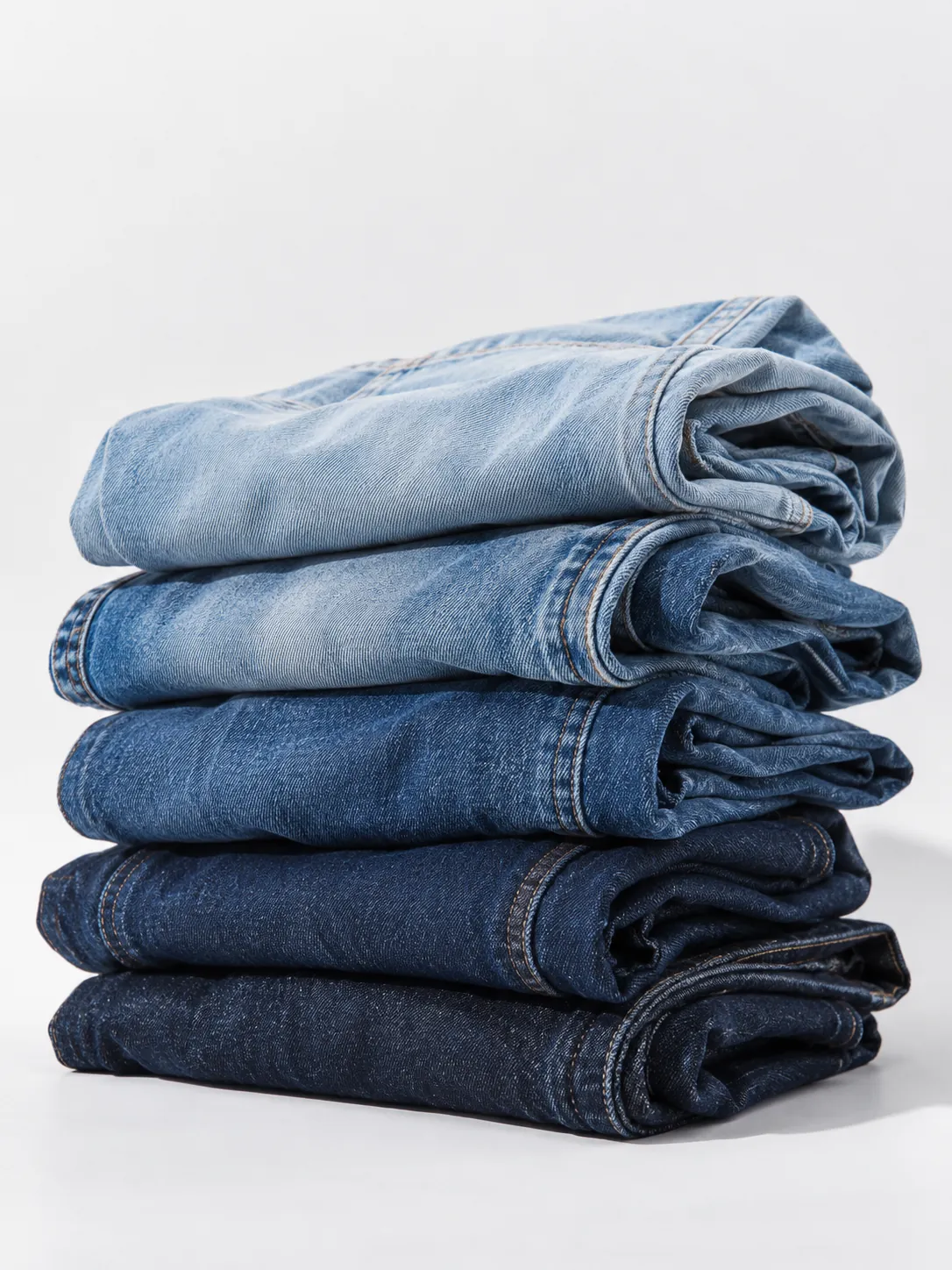 Stack of washed jeans in graded shades